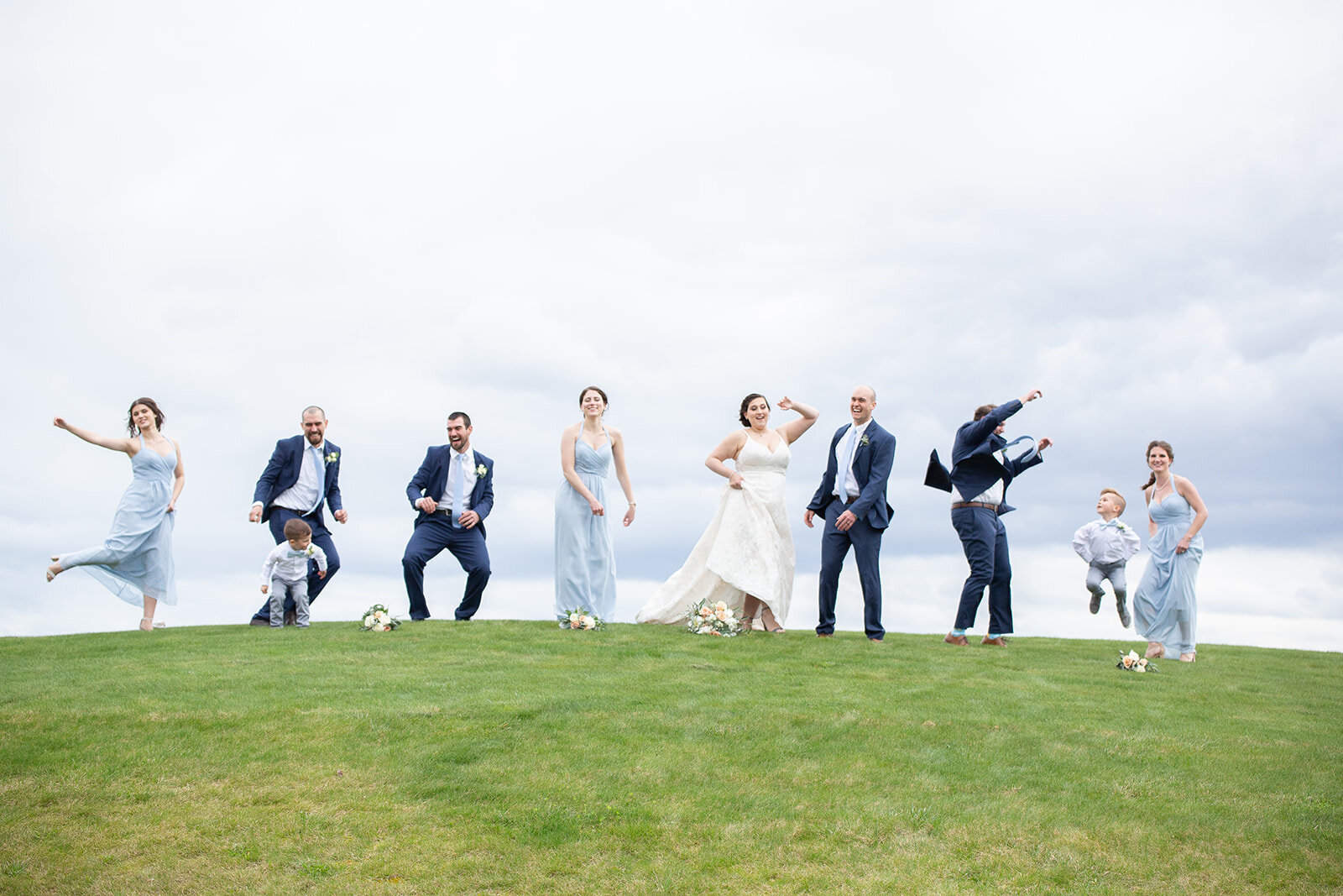 wedding party jumping up in the air for a fun shot