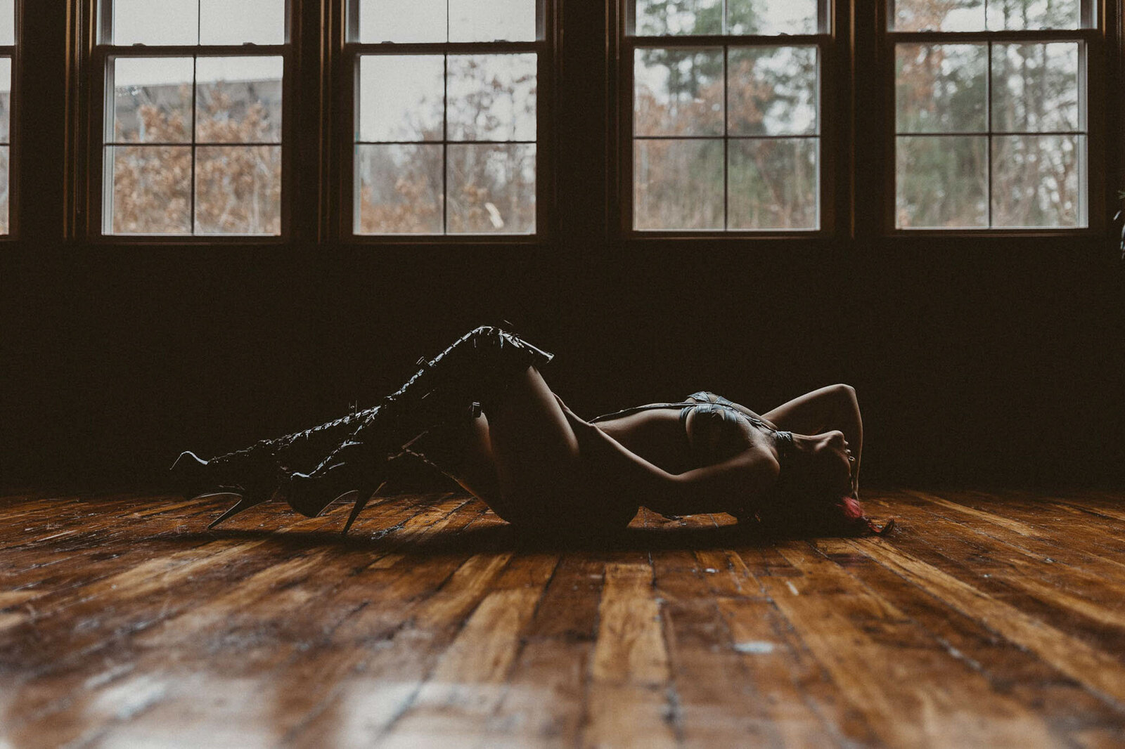 woman in a high boots laying on the floor
