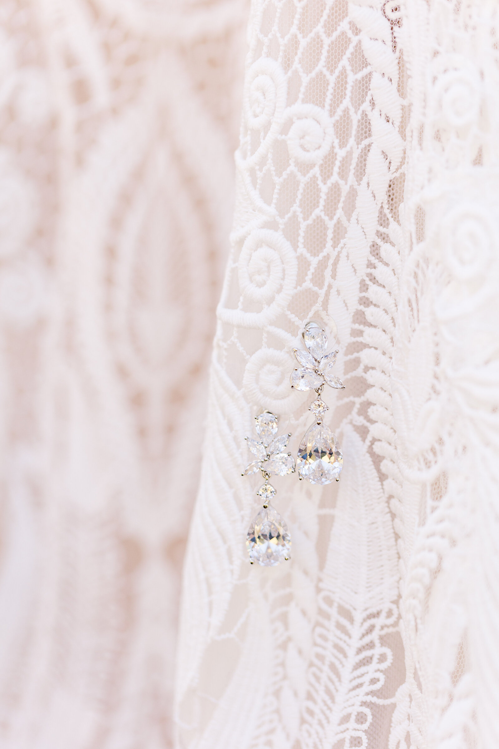 diamond earings on lace bridal gown
