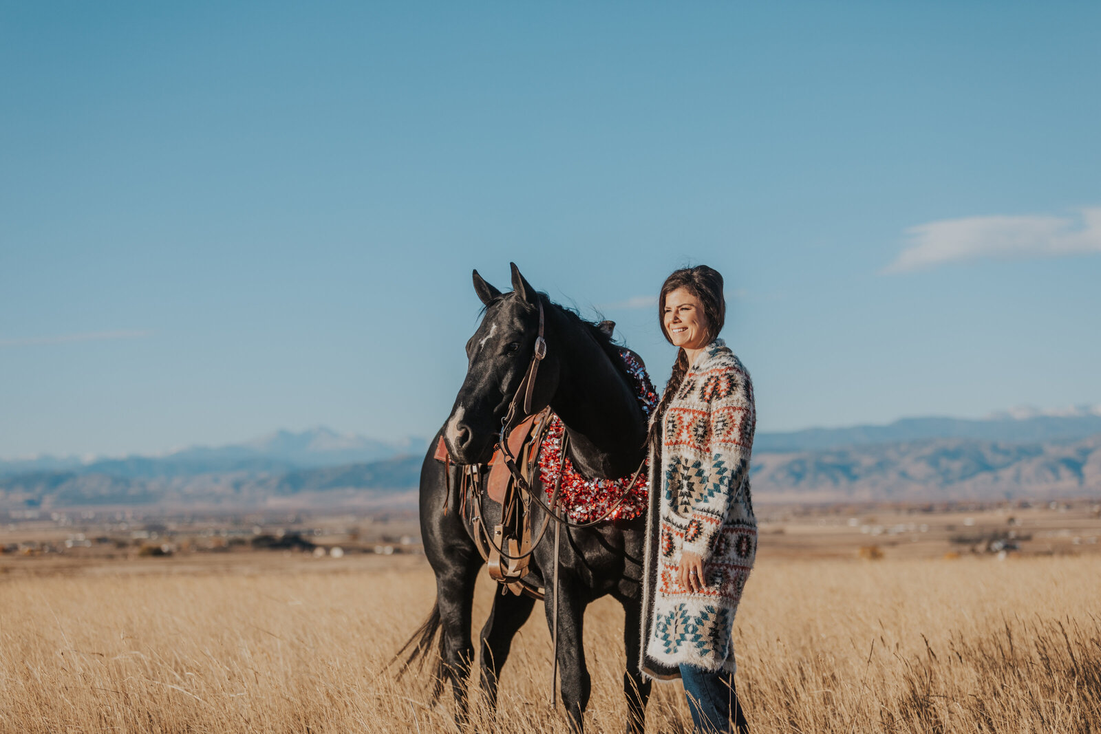 Girl and horse looking at the horizon