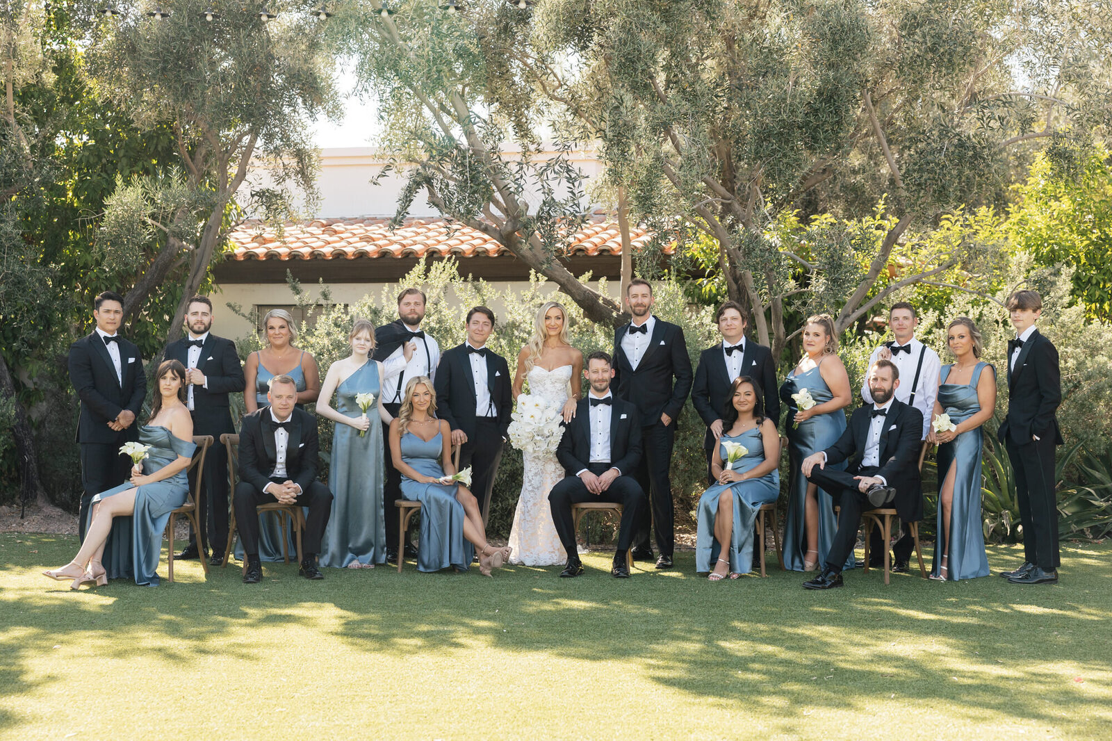 Bride and groom with bridal party poses for a portrait at El Chorro taken by Scottsdale wedding photographer and videographer
