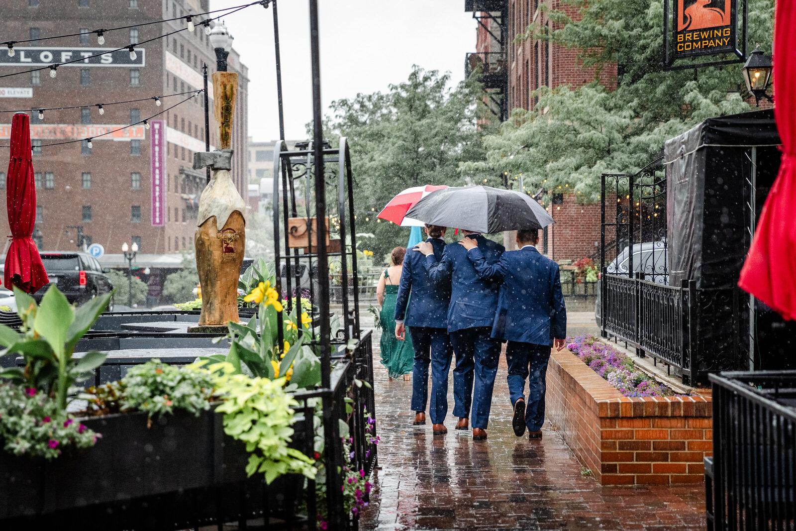 Groomsmen walking in rain  in their tux