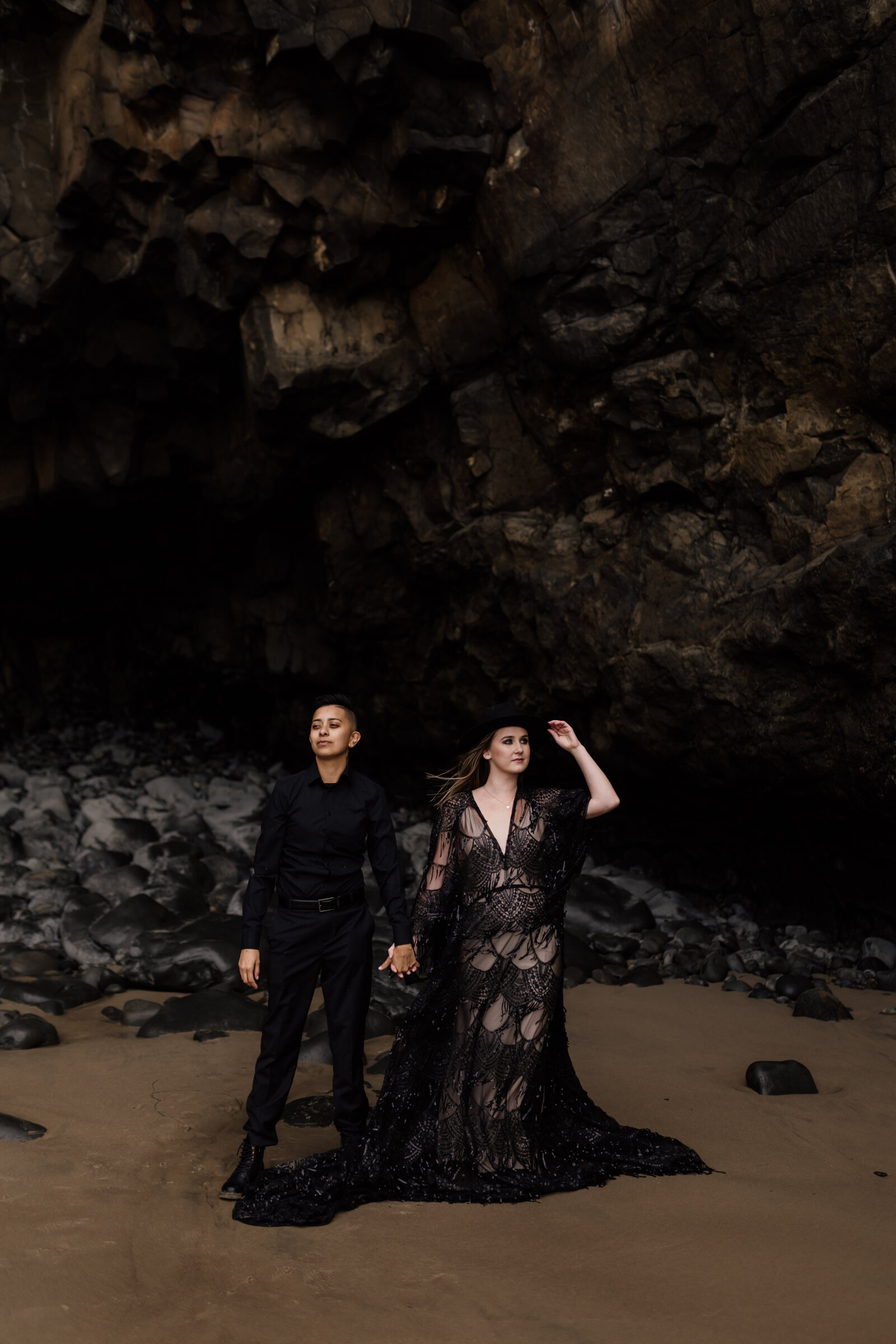 Couple embracing in a moody cave setting, perfect for styled shoots for adventurous photographers in the Pacific Northwest.