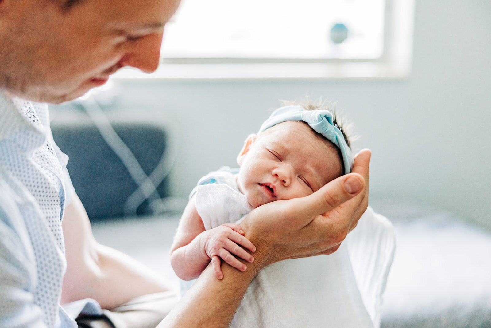 st pete newborn so tiny they can fit in dad's hand