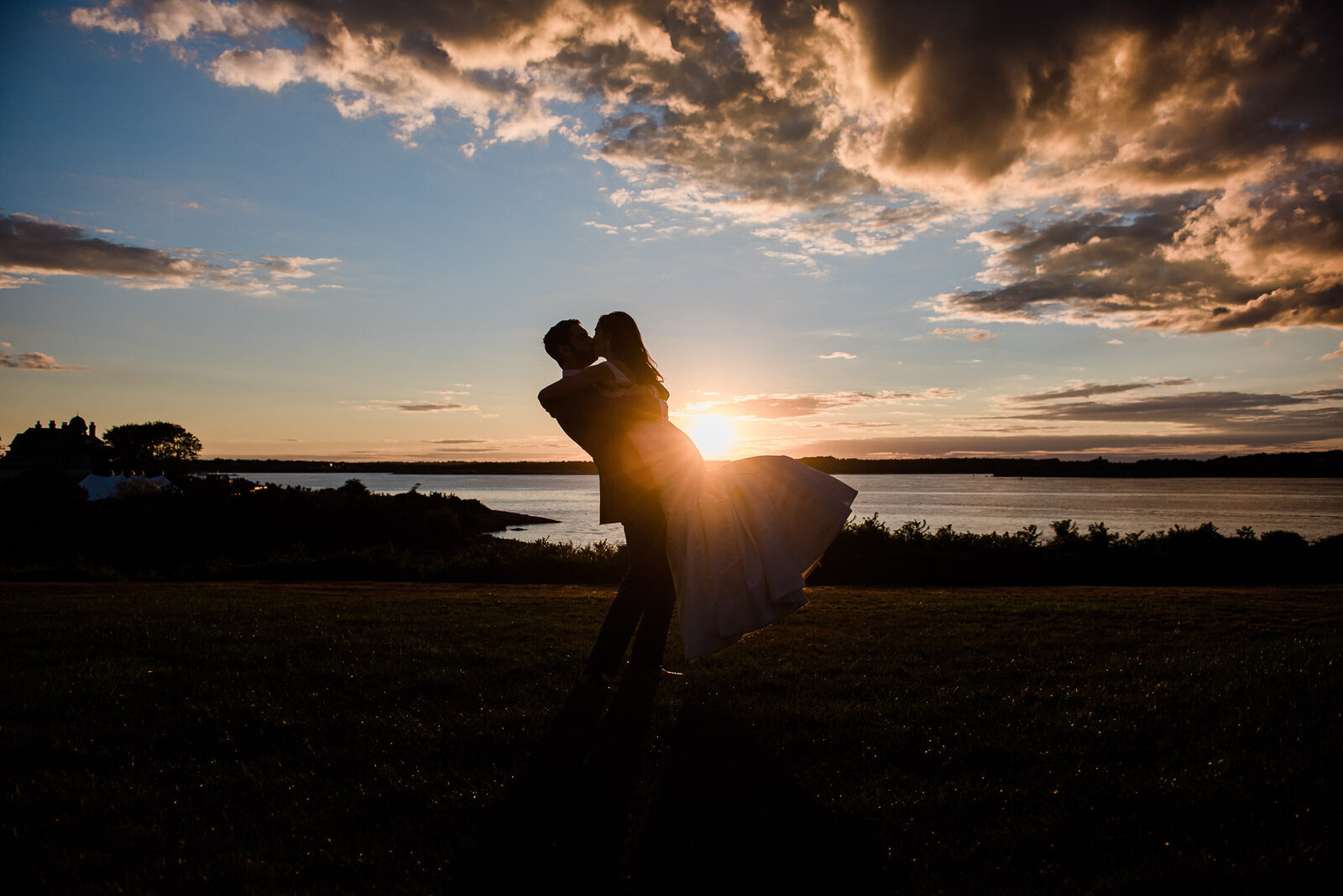 groom pick up bride at sunset