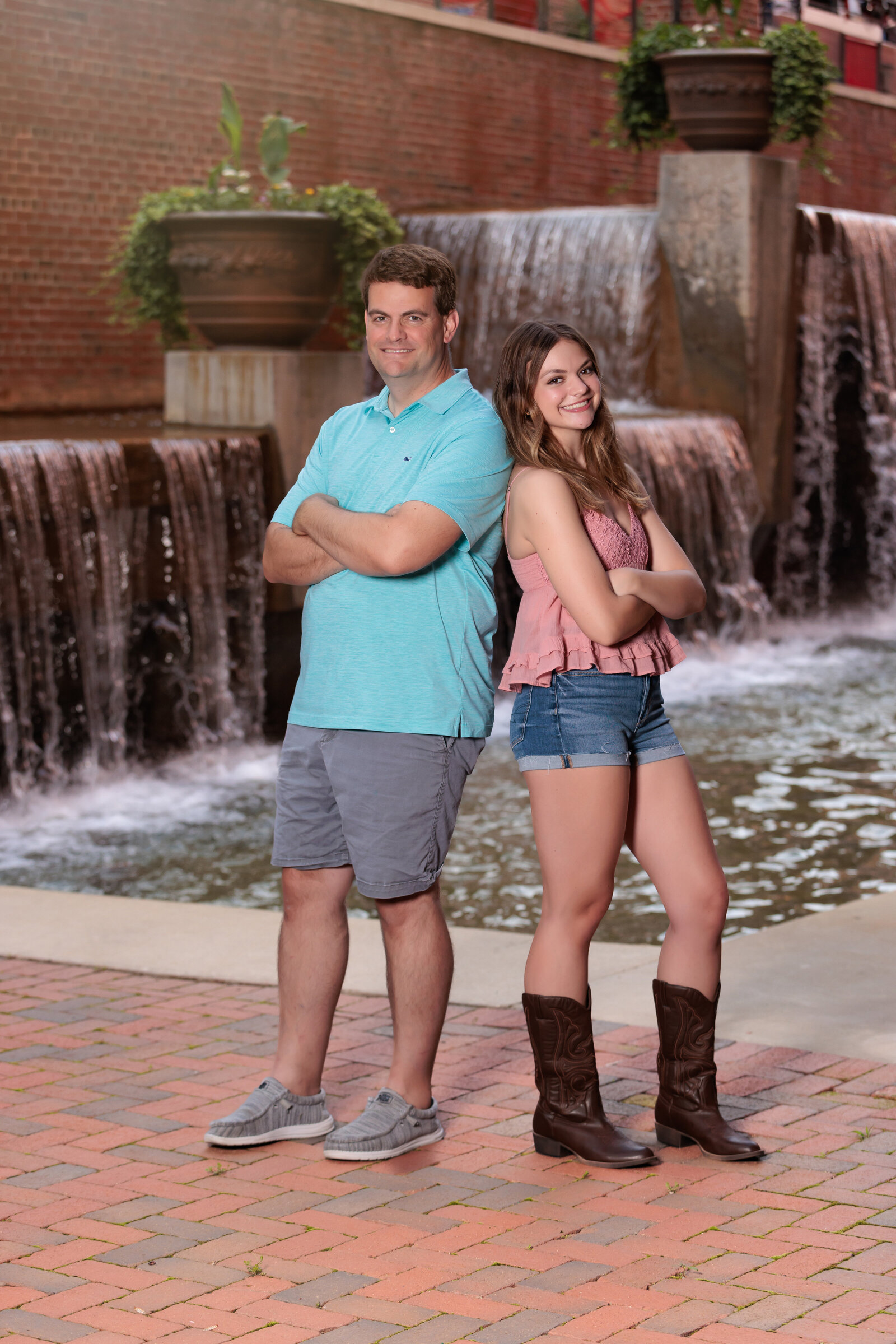 Father and Daughter in front of waterfalls in Durham NC.