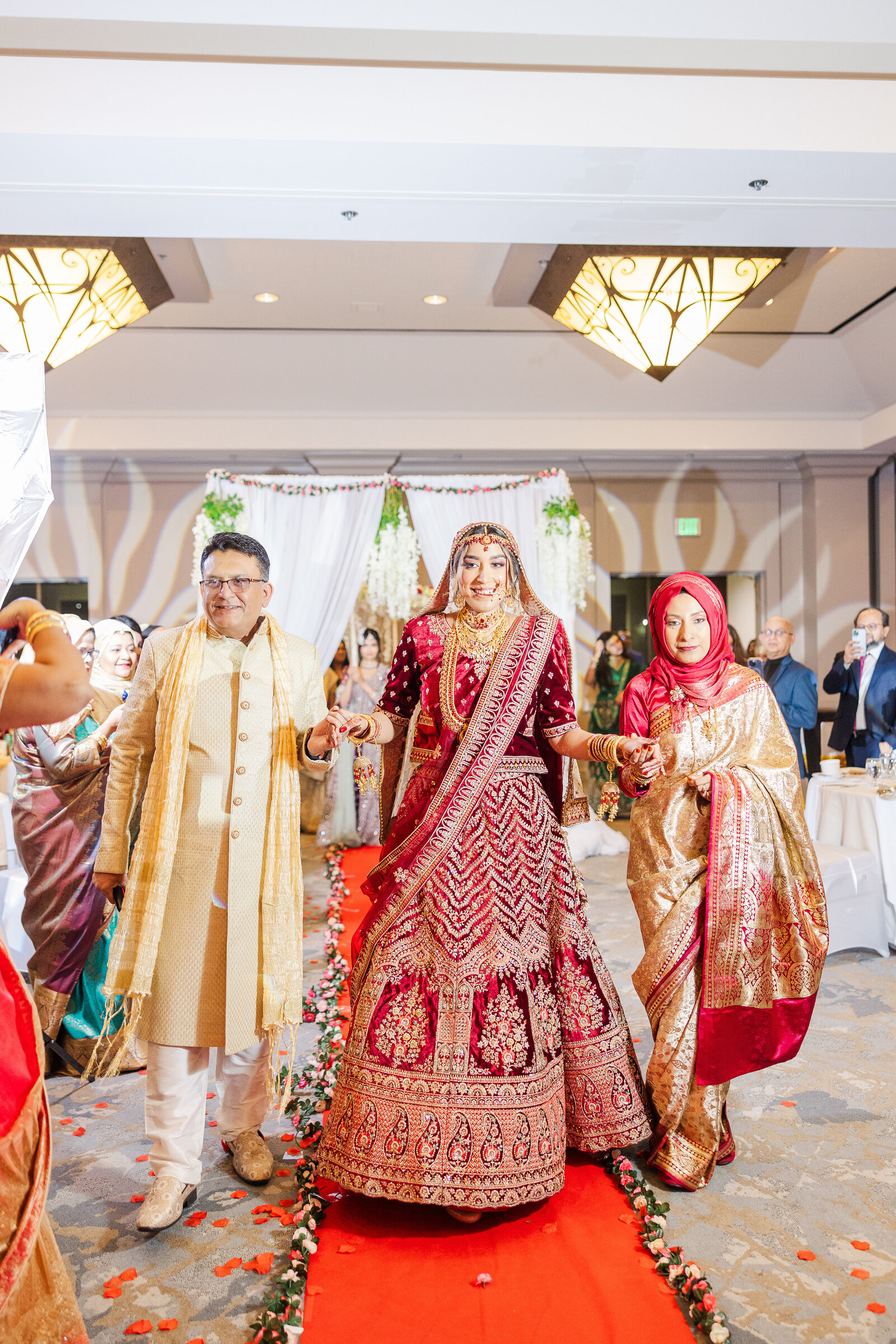 Bride-wedding-venue-entry-with-parents