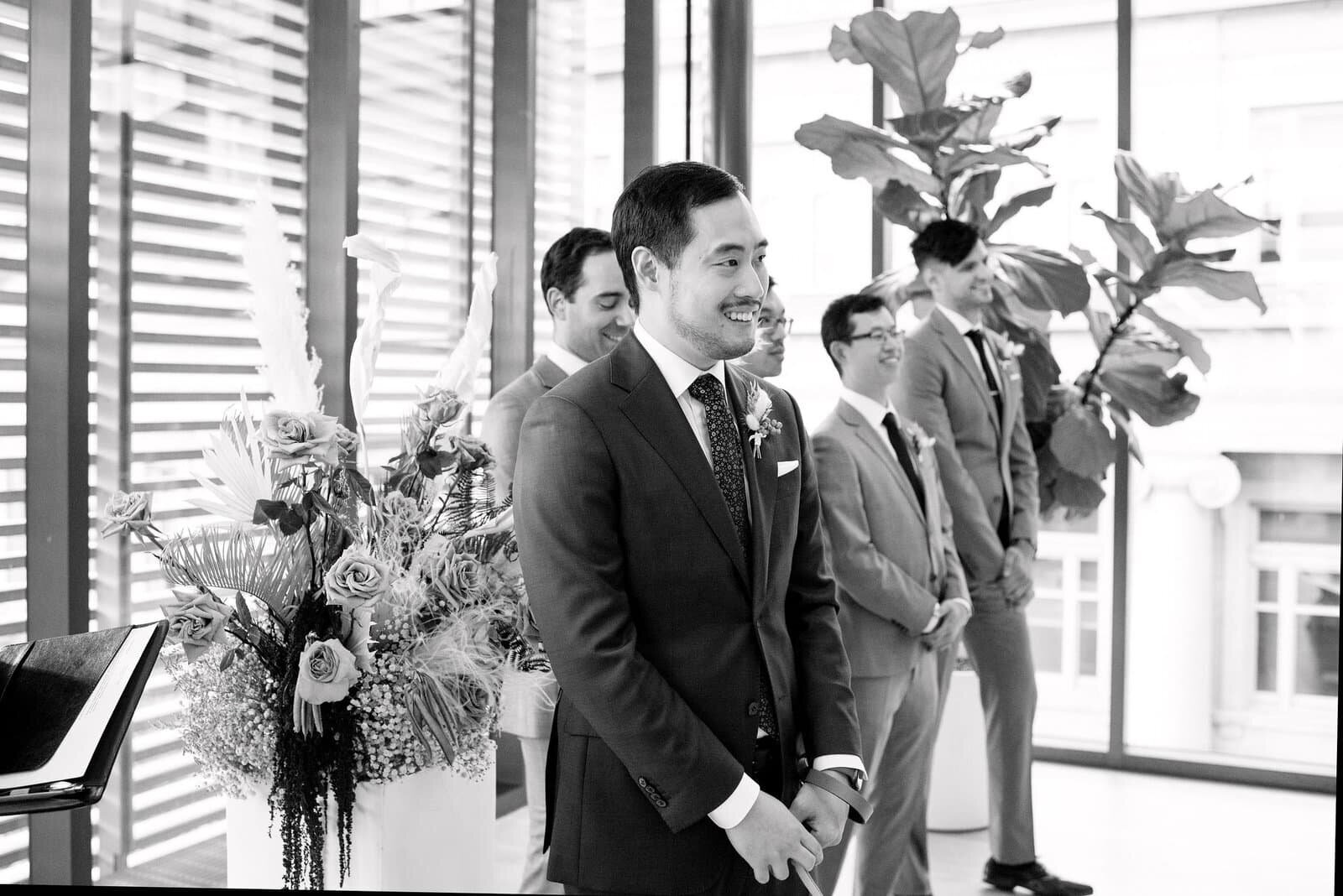 Groom Sees Bride at Elegant Modern Fall Wedding Ceremony at Gardiner Museum Intimate Wedding Toronto Wedding Venue Jacqueline James Photography