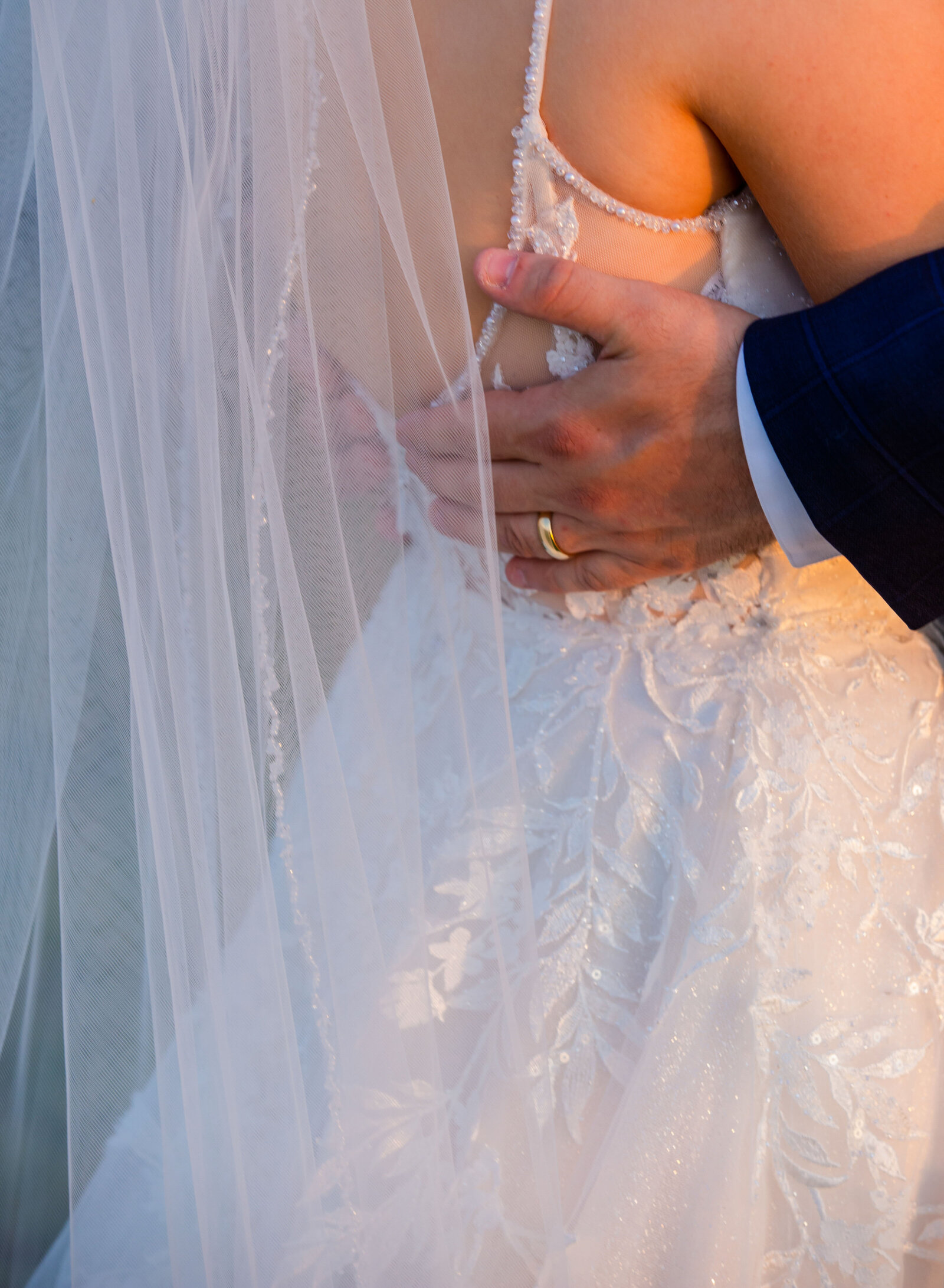 groom's hand on bride's back