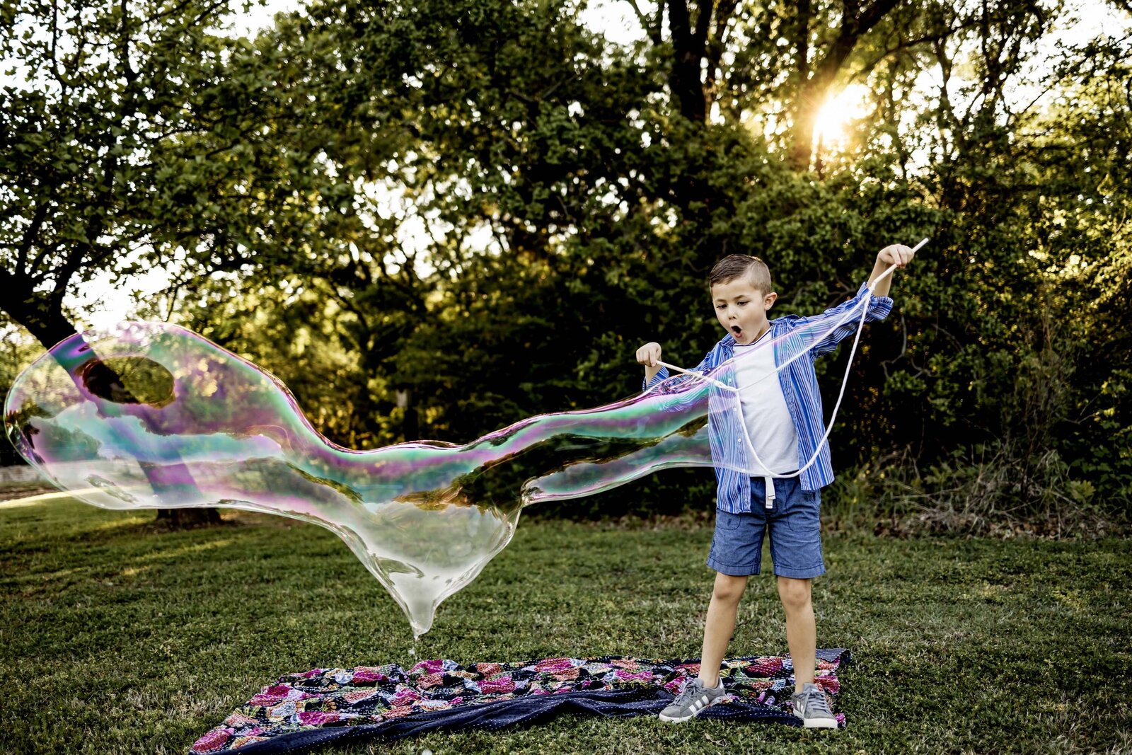 a boy marvels at a giant bubble