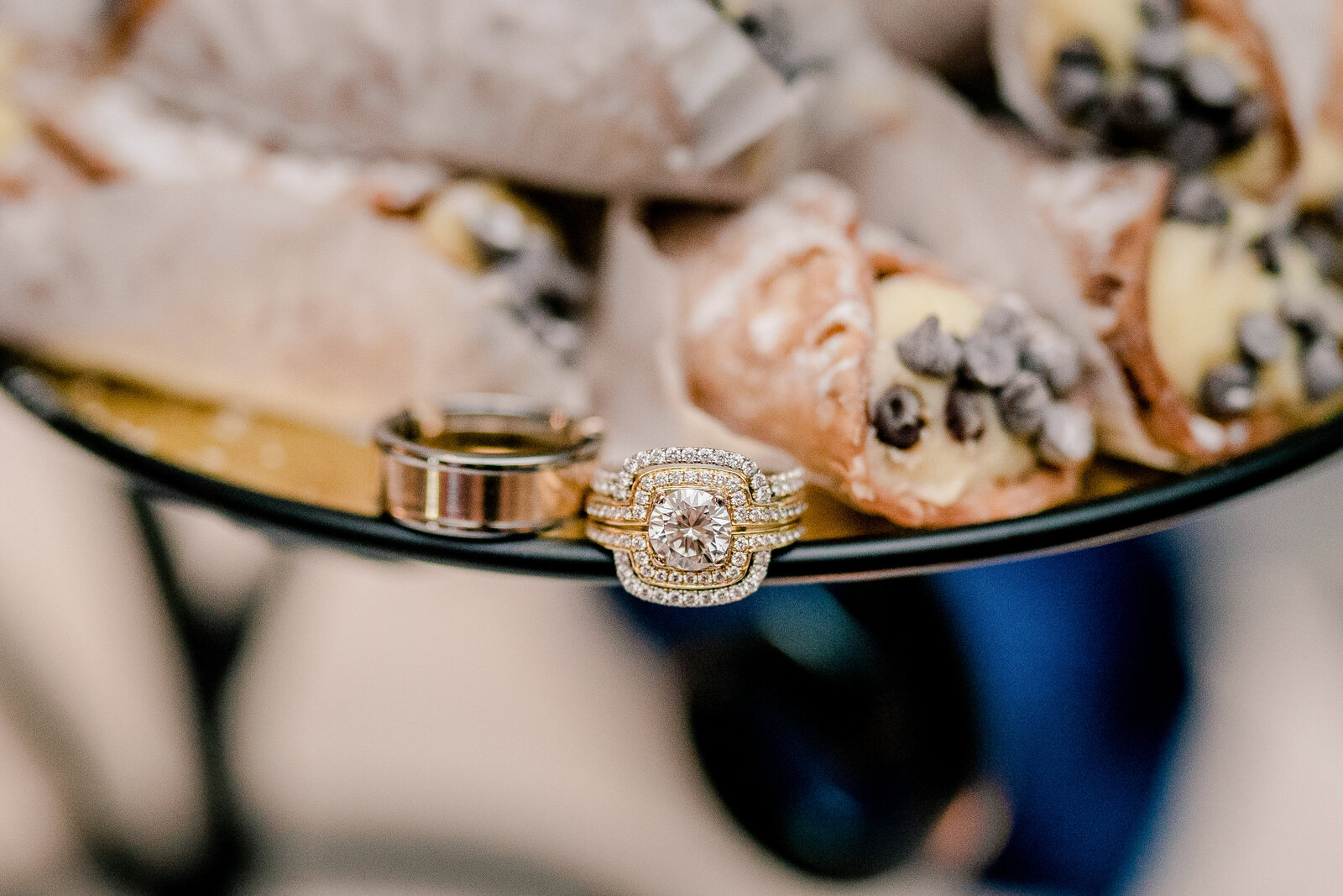 A set of wedding rings sitting on the plate of cannolis at a wedding in Northern Virginia