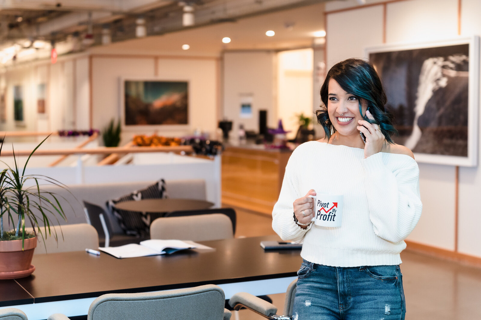 Business Coach on the phone, holding an on-brand coffee mug