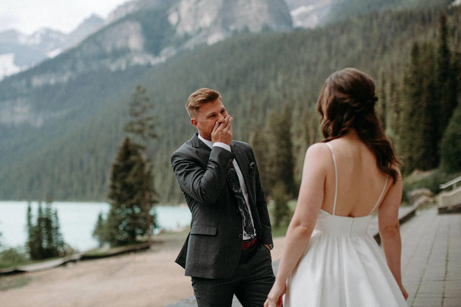 groom seeing bride for the first time in Alberta mountains