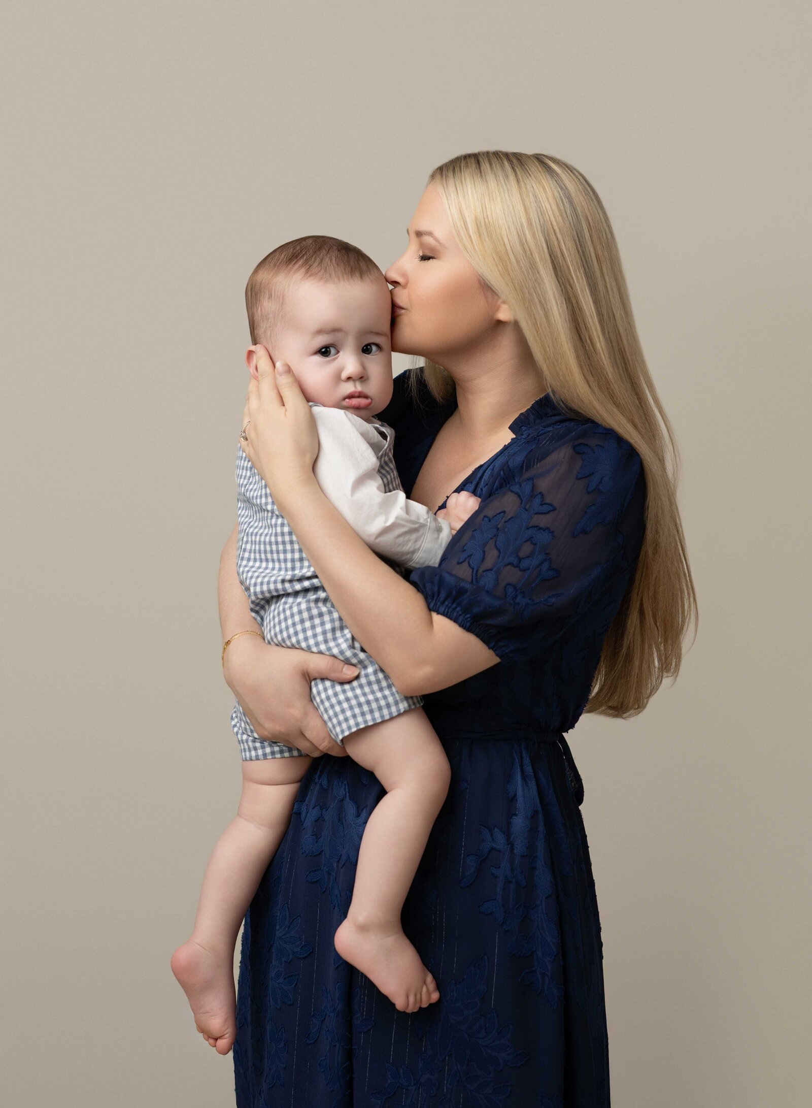 Mommy and baby photo with Mom kissing him on the cheek. Mommy and me photo taken by Jenni Nikki Photography in Atlanta, GA.