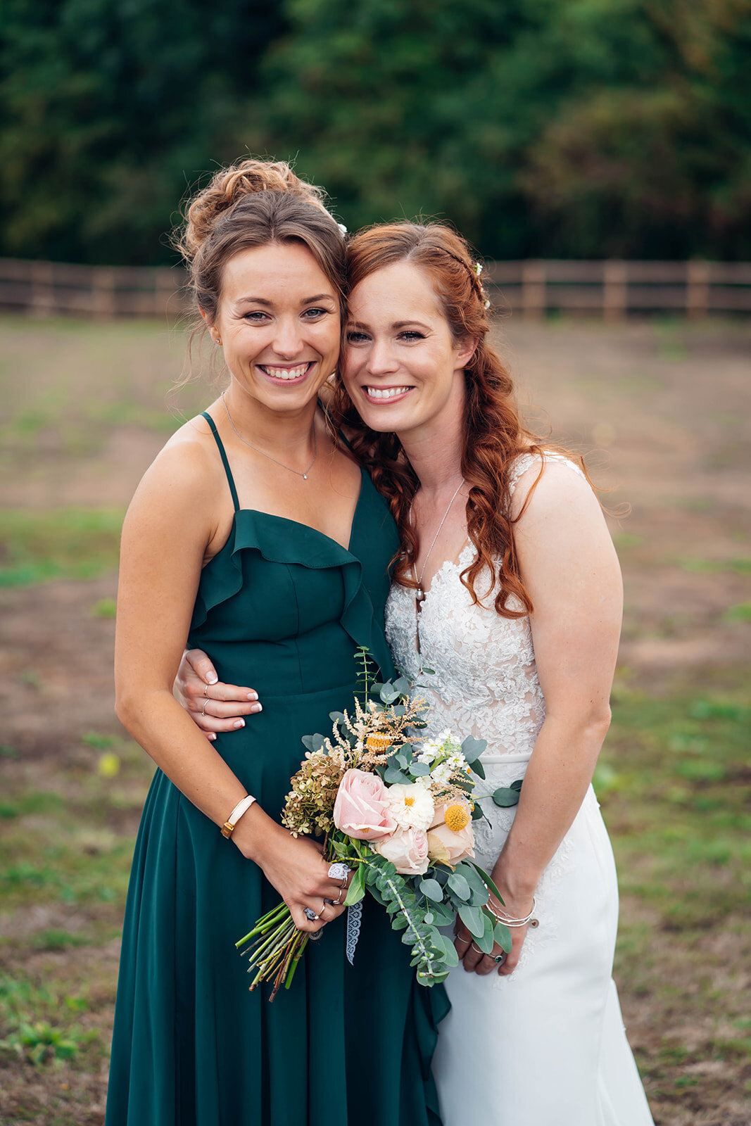 candid-hug-with-bridesmaid-and-bride-at-cotswold-wedding