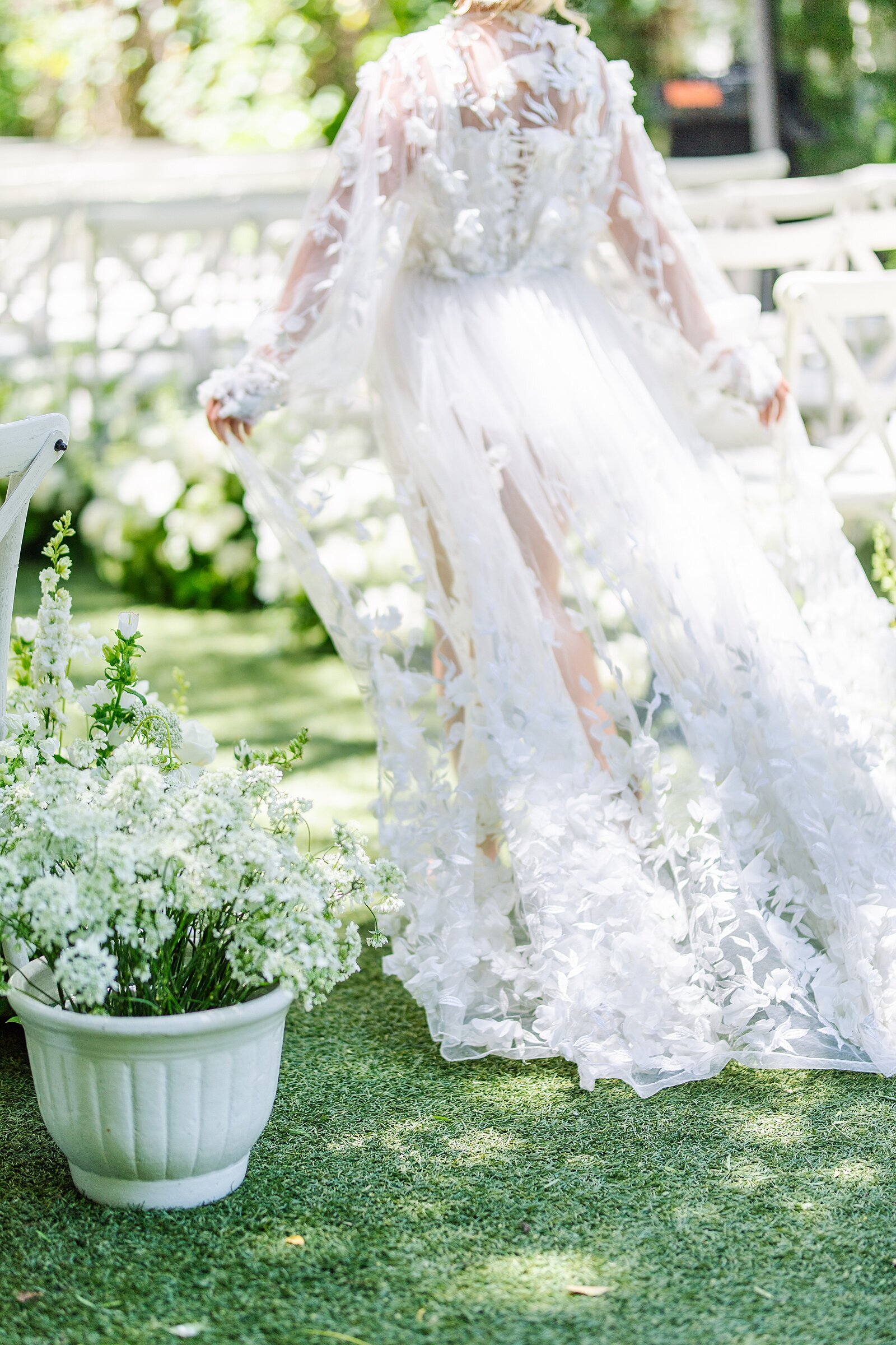 Bride running down floral aisle in lace robe at Green Gables wedding estate in San Marcos.