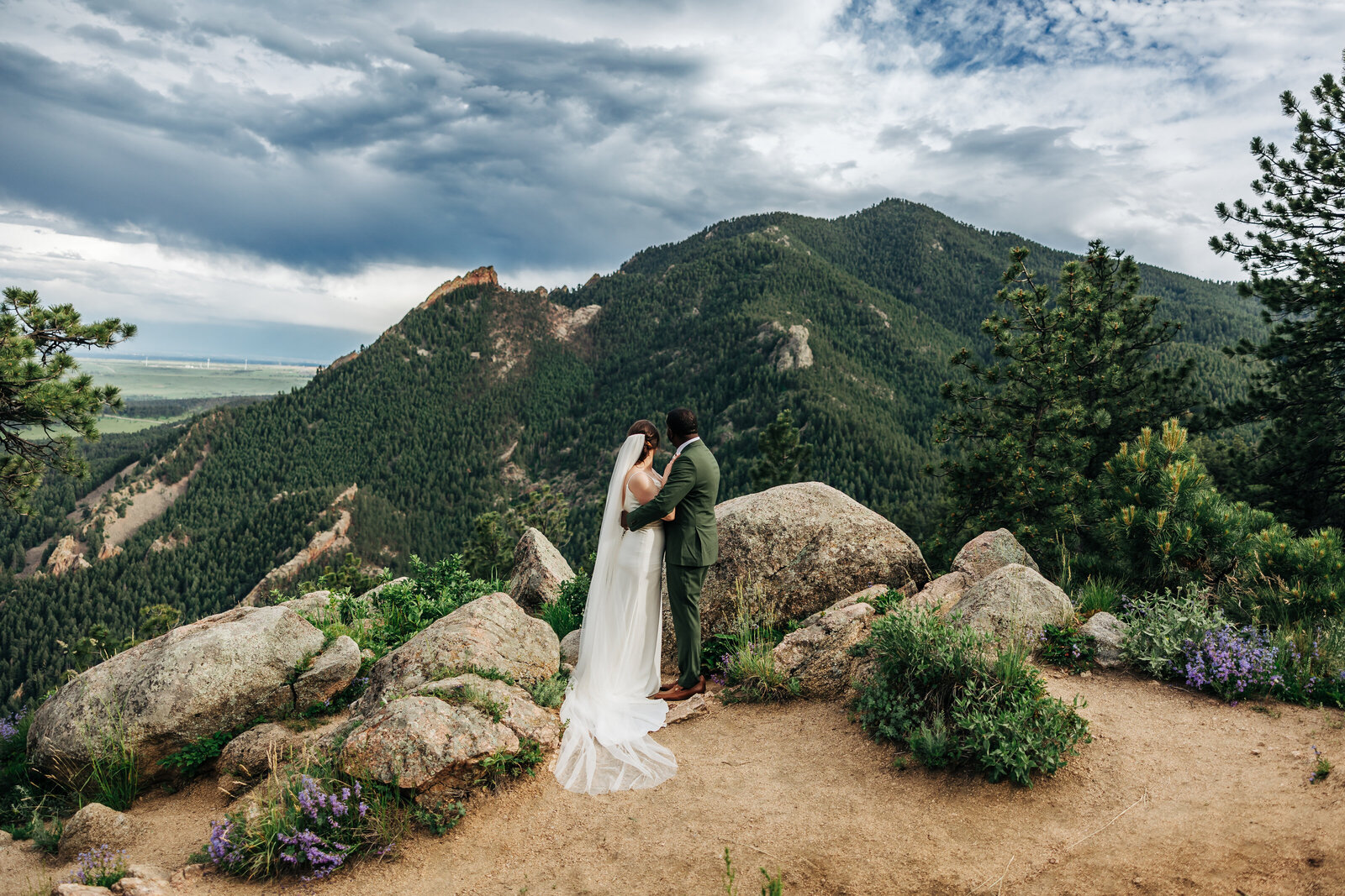 Bride and groom overlooking mountainous view after intimate elopement in Colorado
