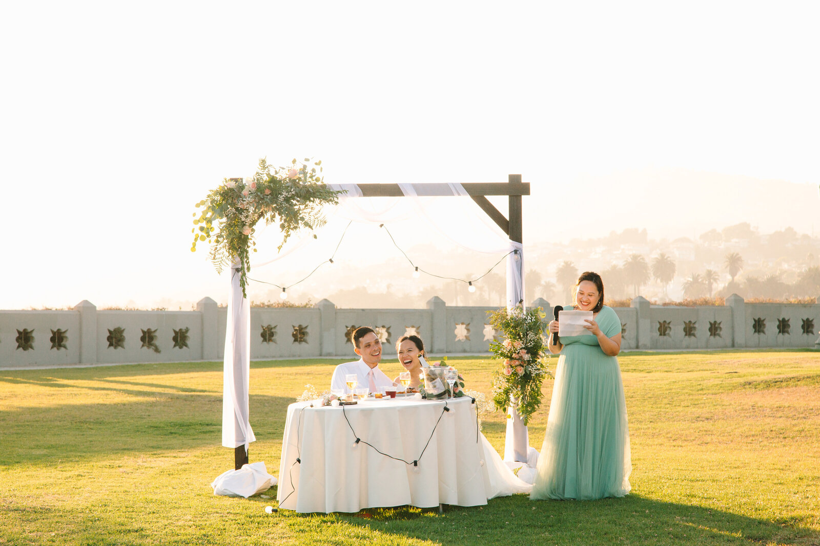 A bridesmaid gives a speech to the groom at a wedding reception.