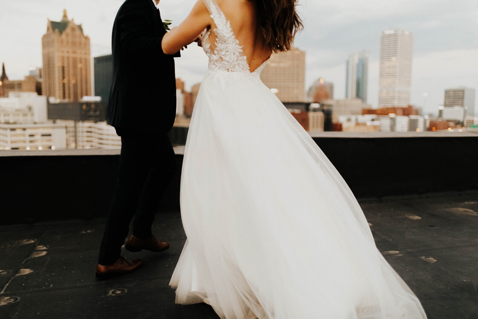 Bride and groom dance on rooftop