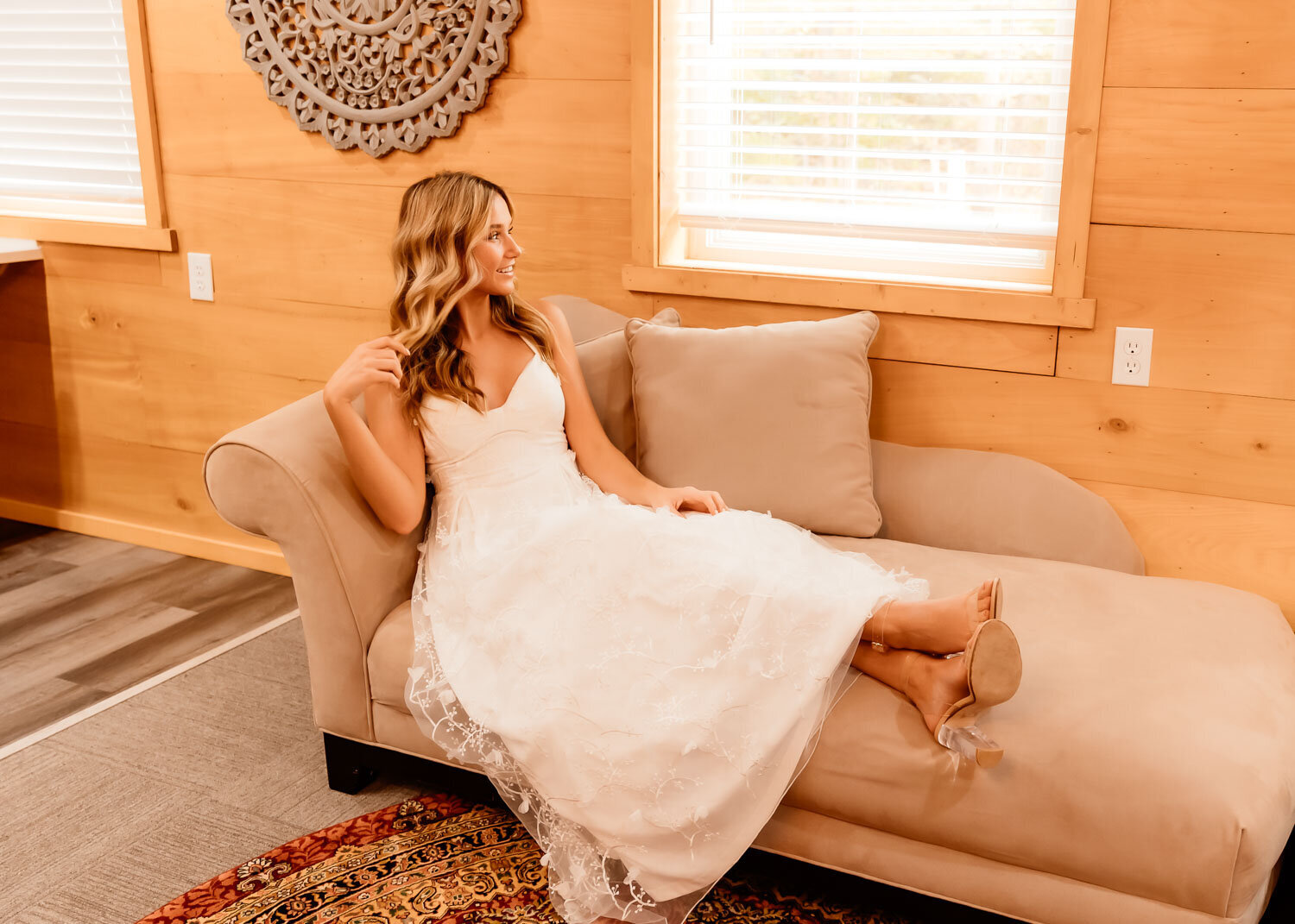 Bride in her wedding gown sitting down on an elegant chair