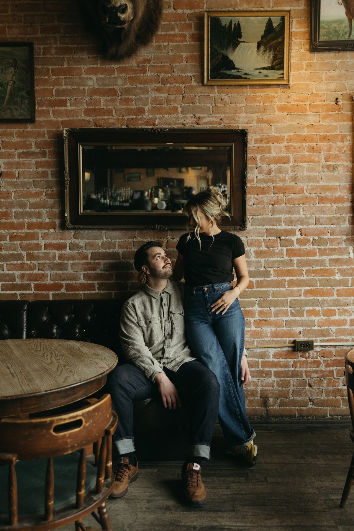 Couple at bar with brick walls by destination wedding photographers