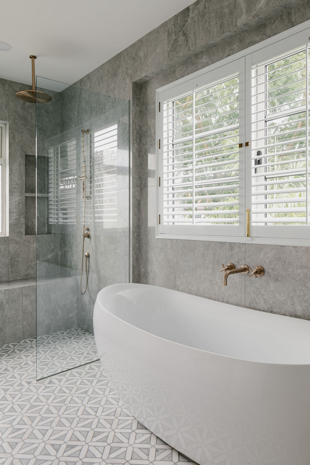 White marble flooring and bath tub in bathroom