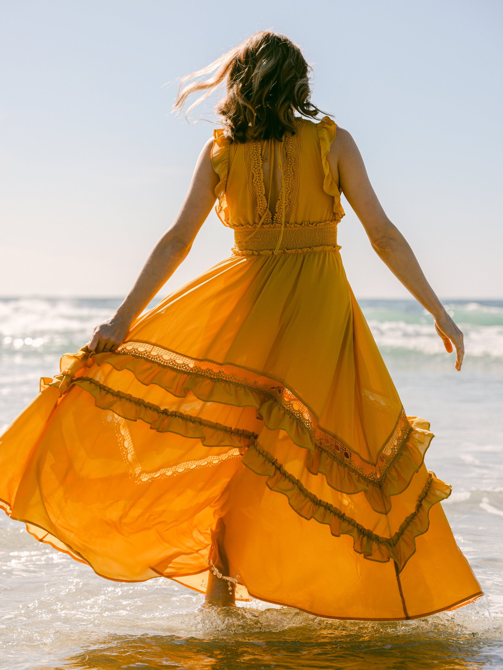 boho girl at beach in the ocean water california fashion photography