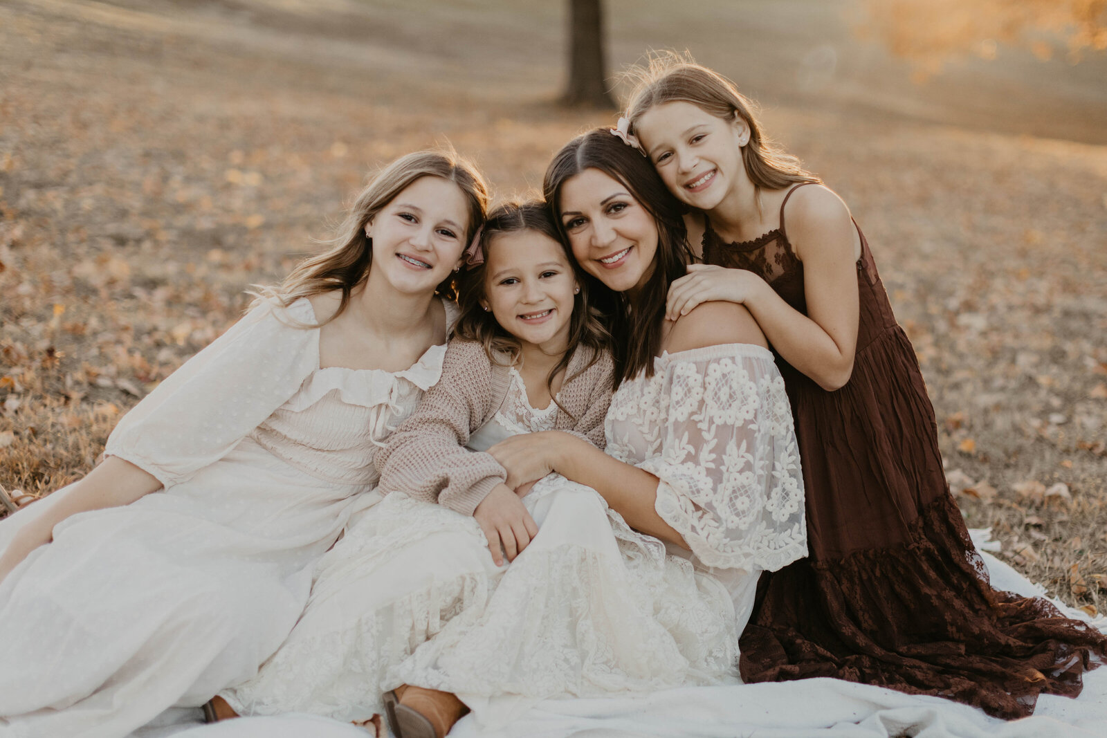 Sisters and mom in close embrace.