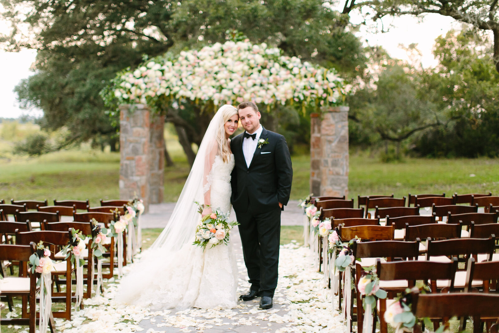 bride and groom standing in front of the Grove at Ma Maison