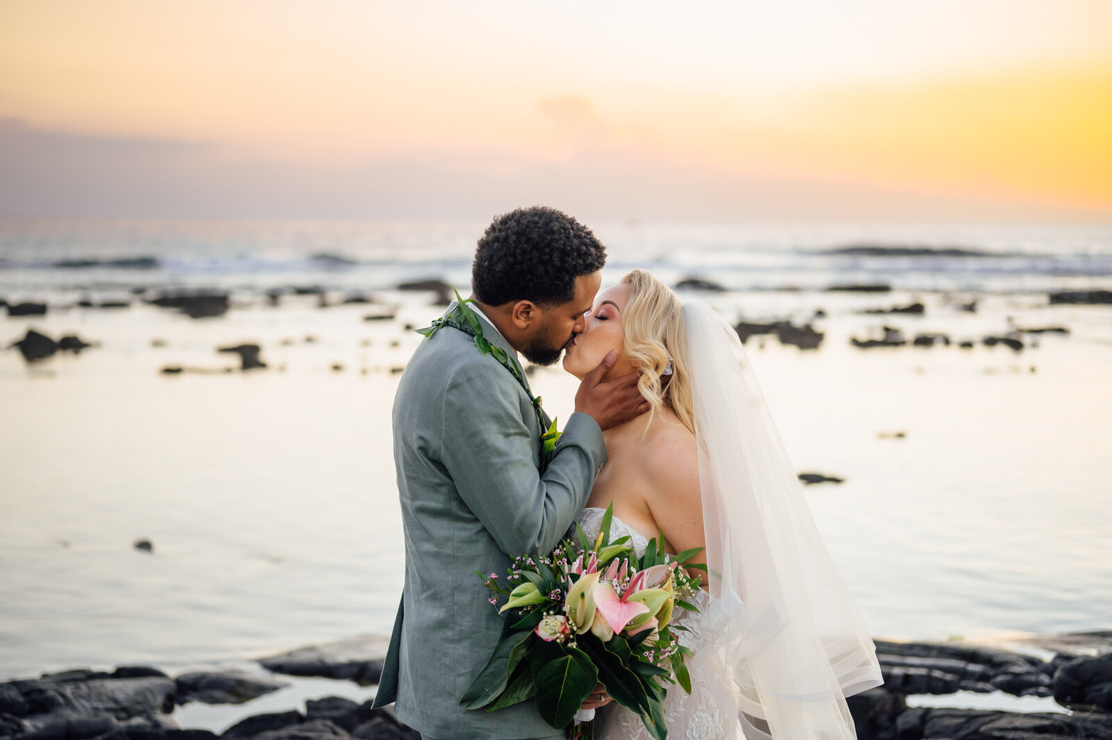 grooms kisses bride during big island wedding