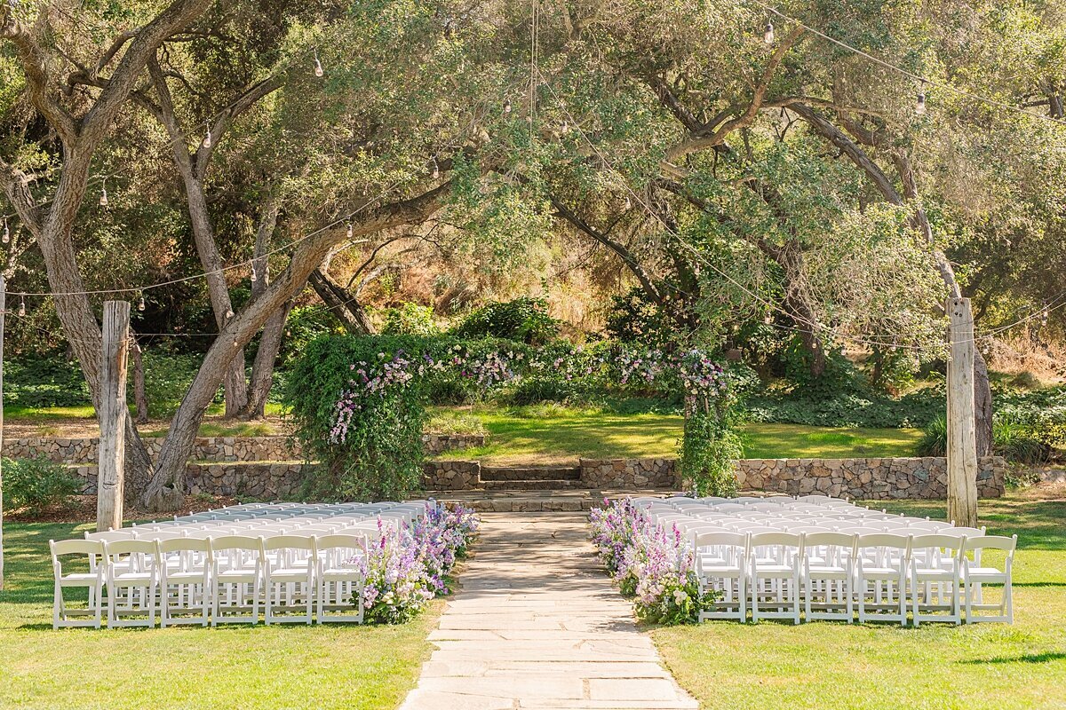 Ceremony set up with blue and purple flowers at The Havens Country Club in VIsta, California.