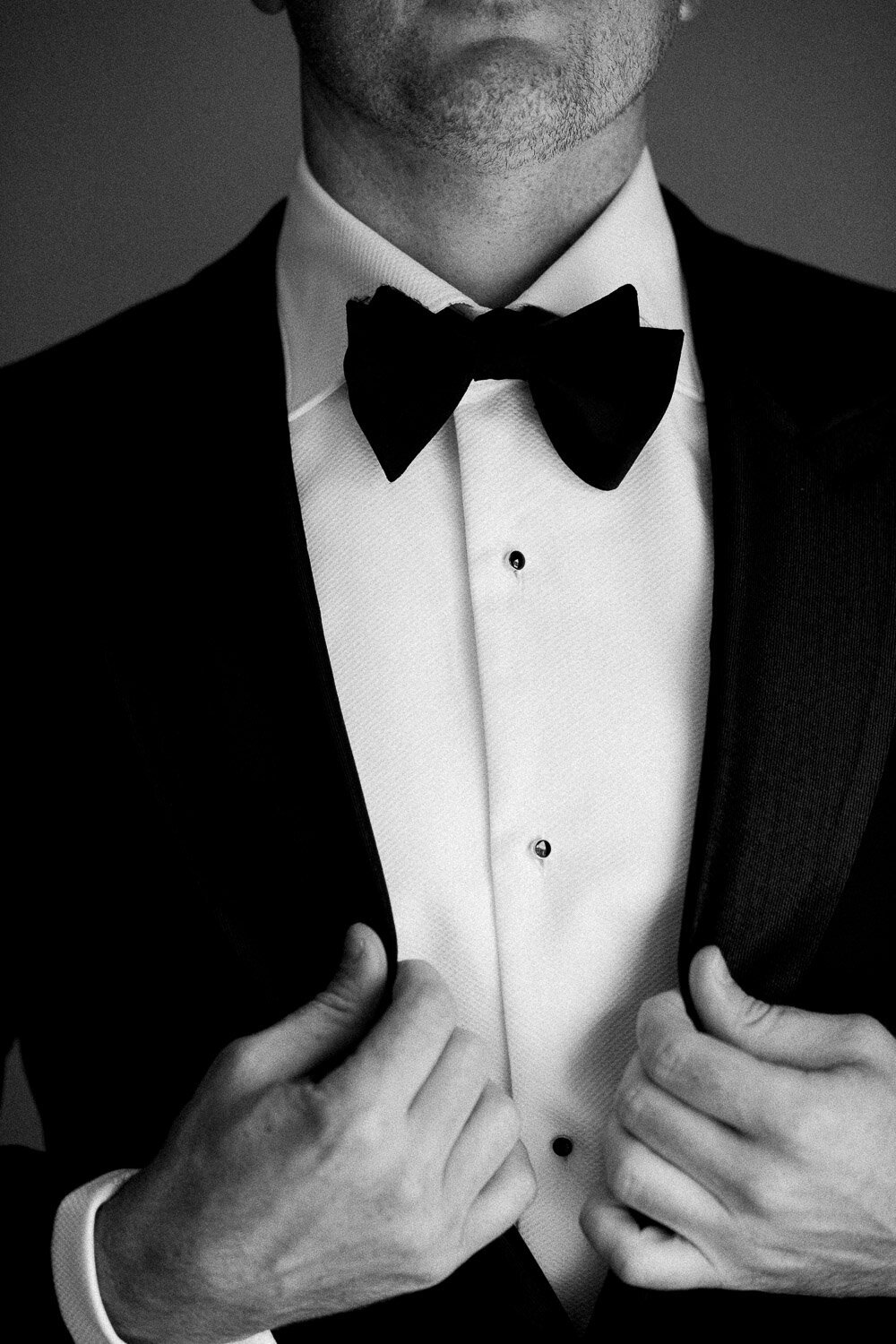 detail of groom jacket and bow tie