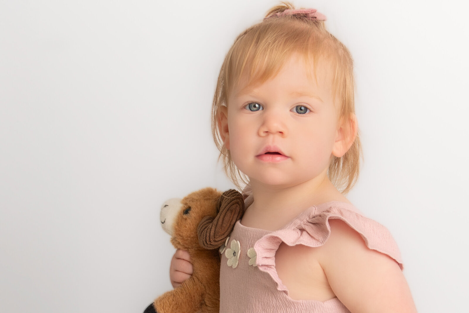 two year old preschool girl smiles for school pictures