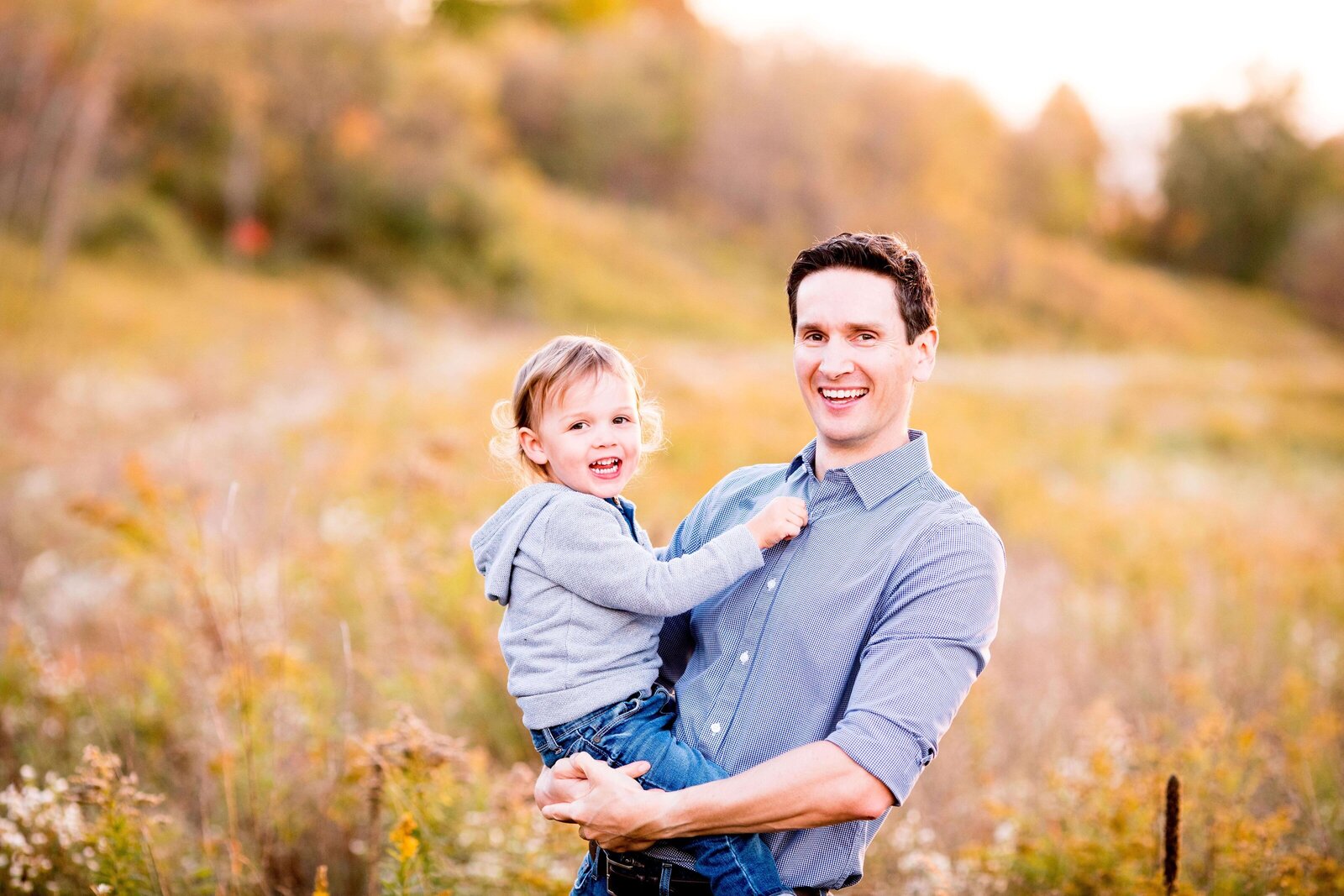 Young son laughs with his father in Komoka Provincial Park