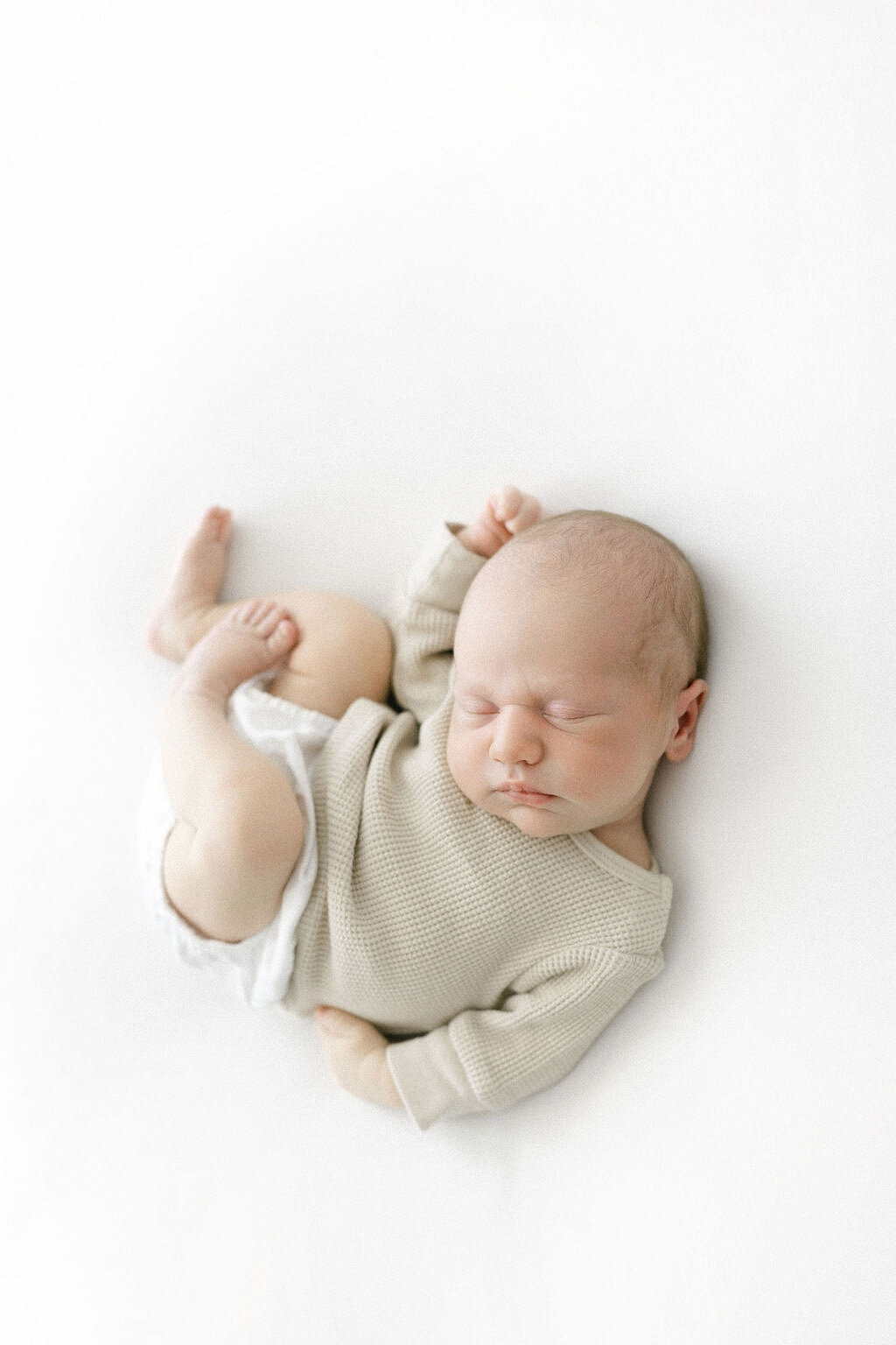 Natural newborn photography Grand Forks | Baby boy posed on white blanket