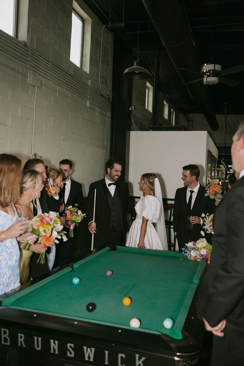 bridal party around pool table by idaho elopement photographer Erica Rochelle photography