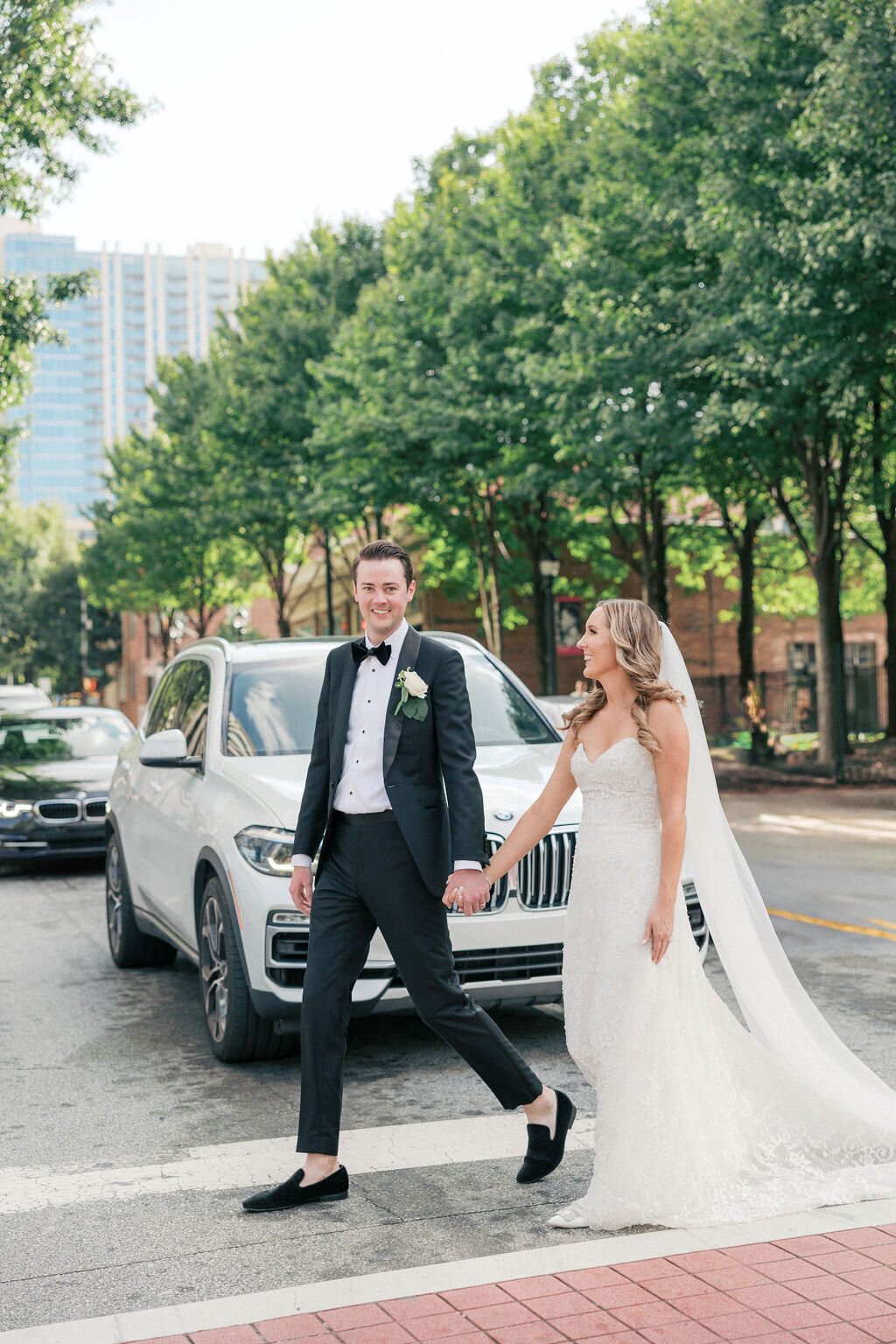 Bride and groom walk across street in downtown Atlanta Georgia