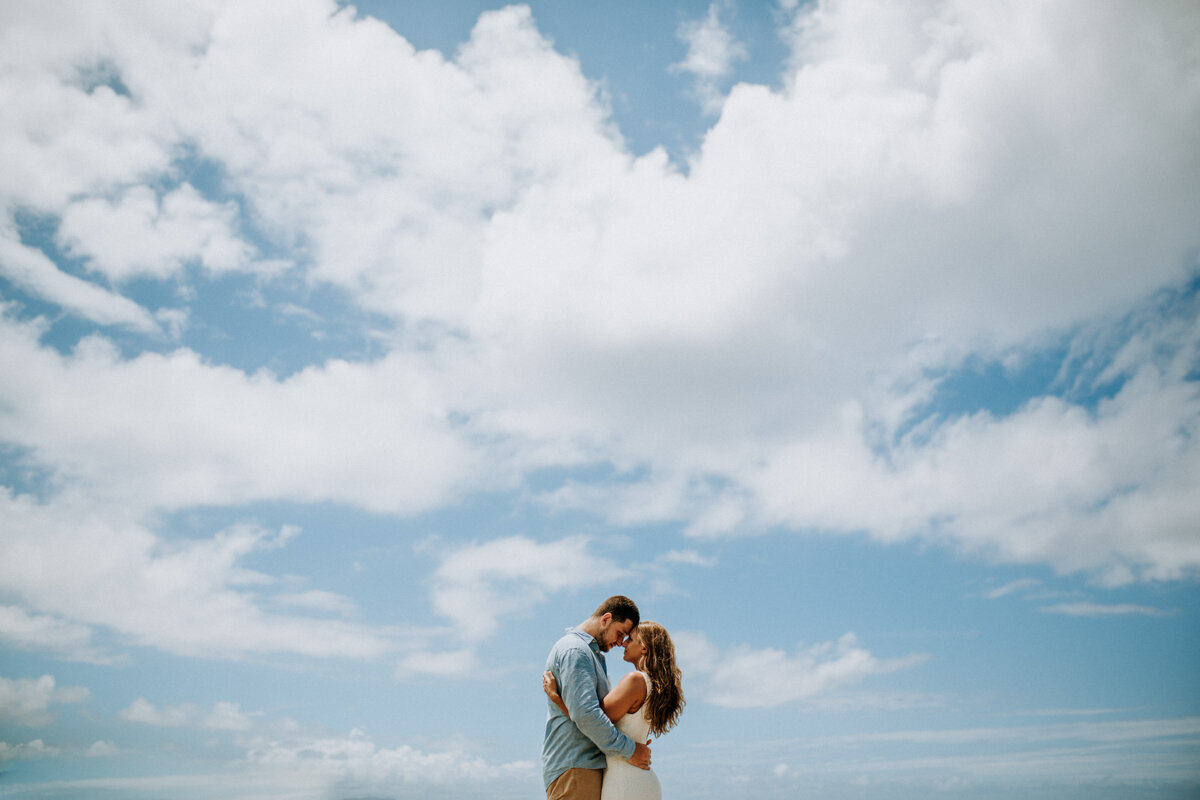 bride and groom under beautiful sky