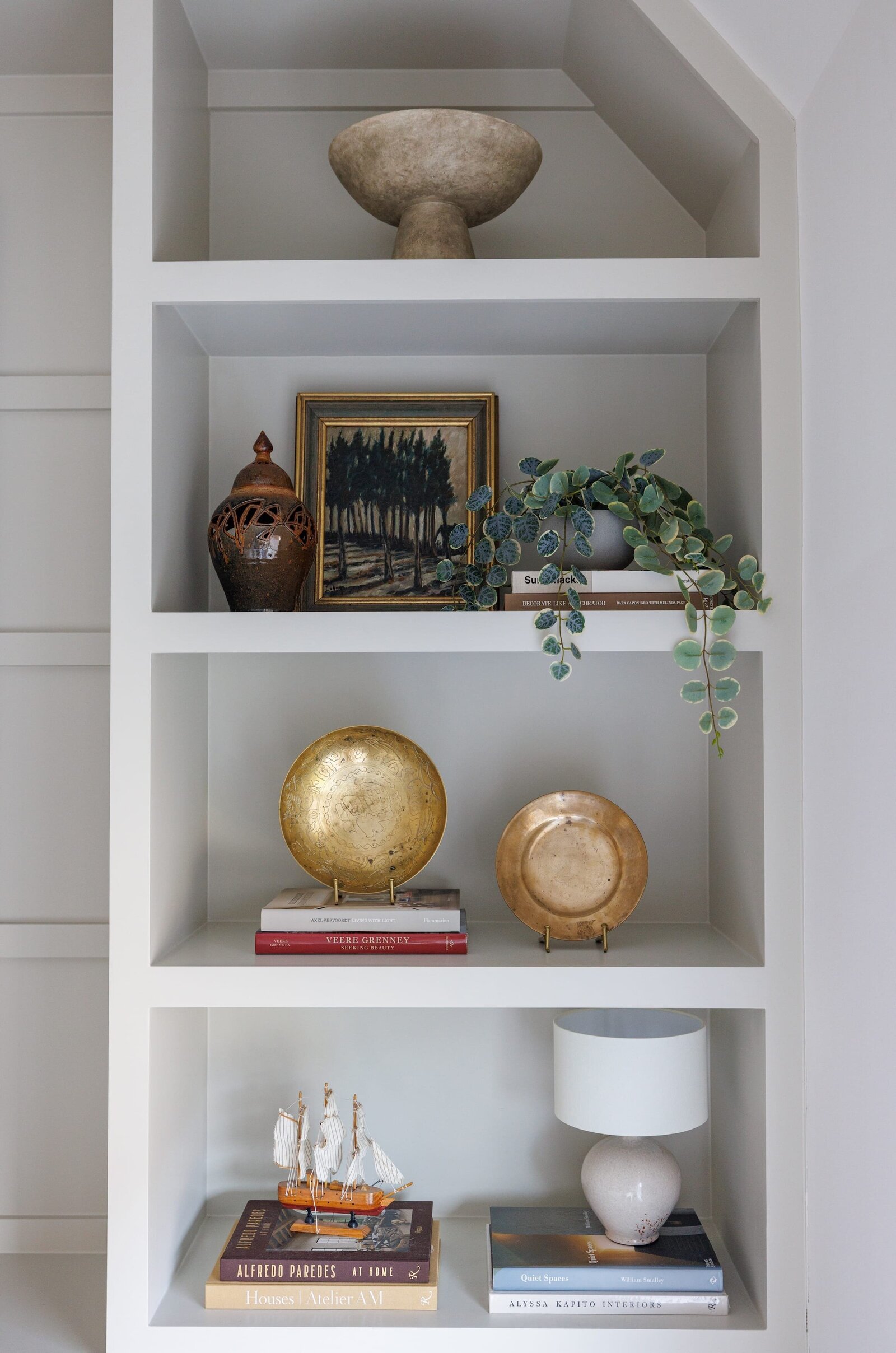 vision and hammer styled shelves with gold plate and ivy plant