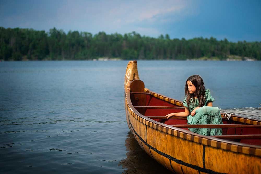 voyagers-national-park-canoe-french-explorer-little-girl-sitting-red-green-blue-water-forest