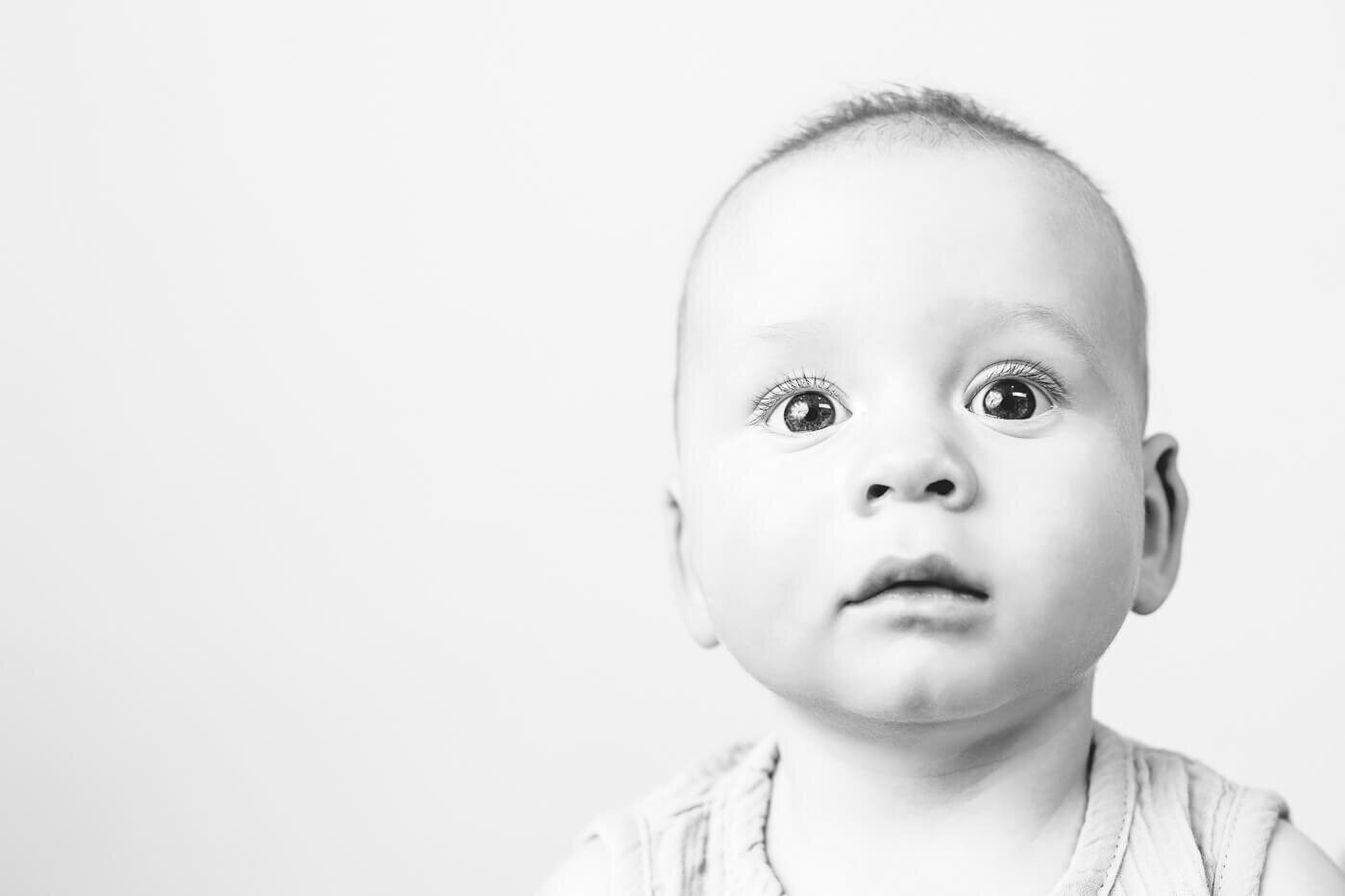 Surprised baby looking at Tampa photographer