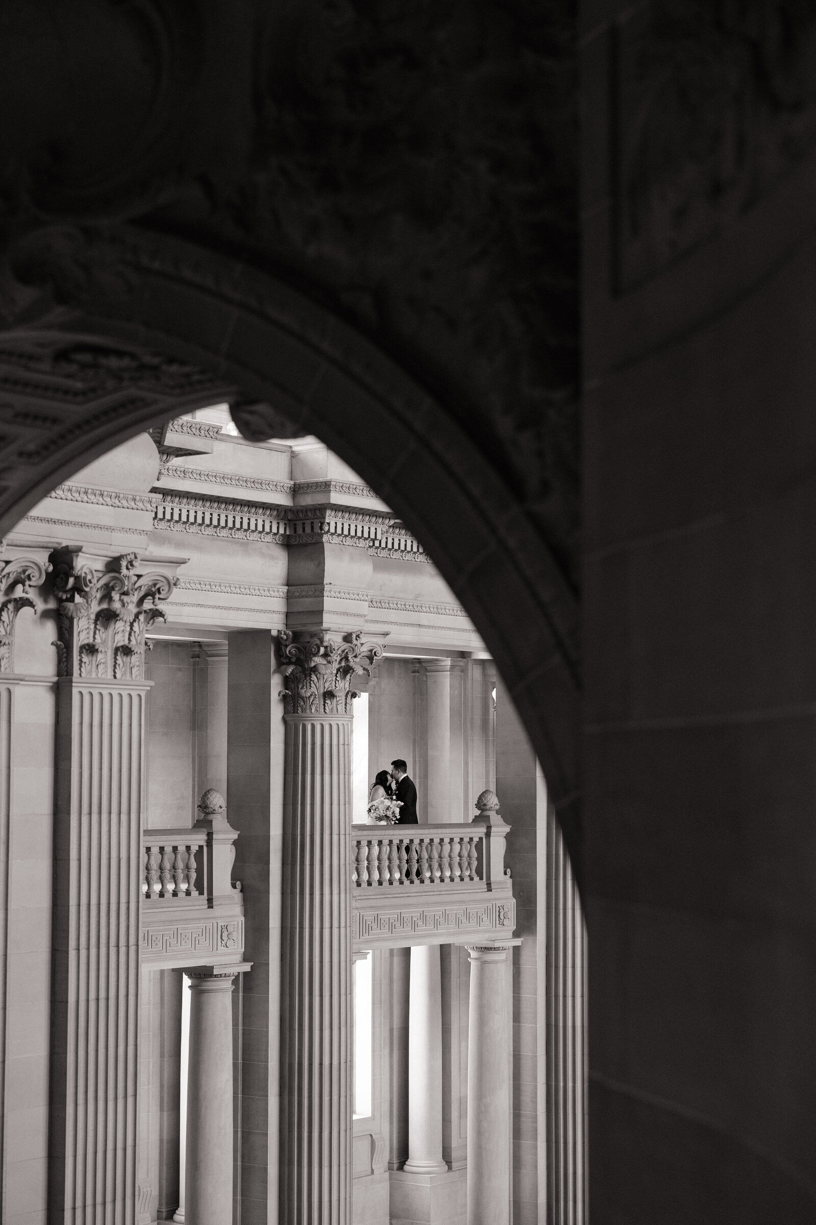 Bride and groom embrace across balcony taken by best Northern California wedding photographer, Erica Rochelle