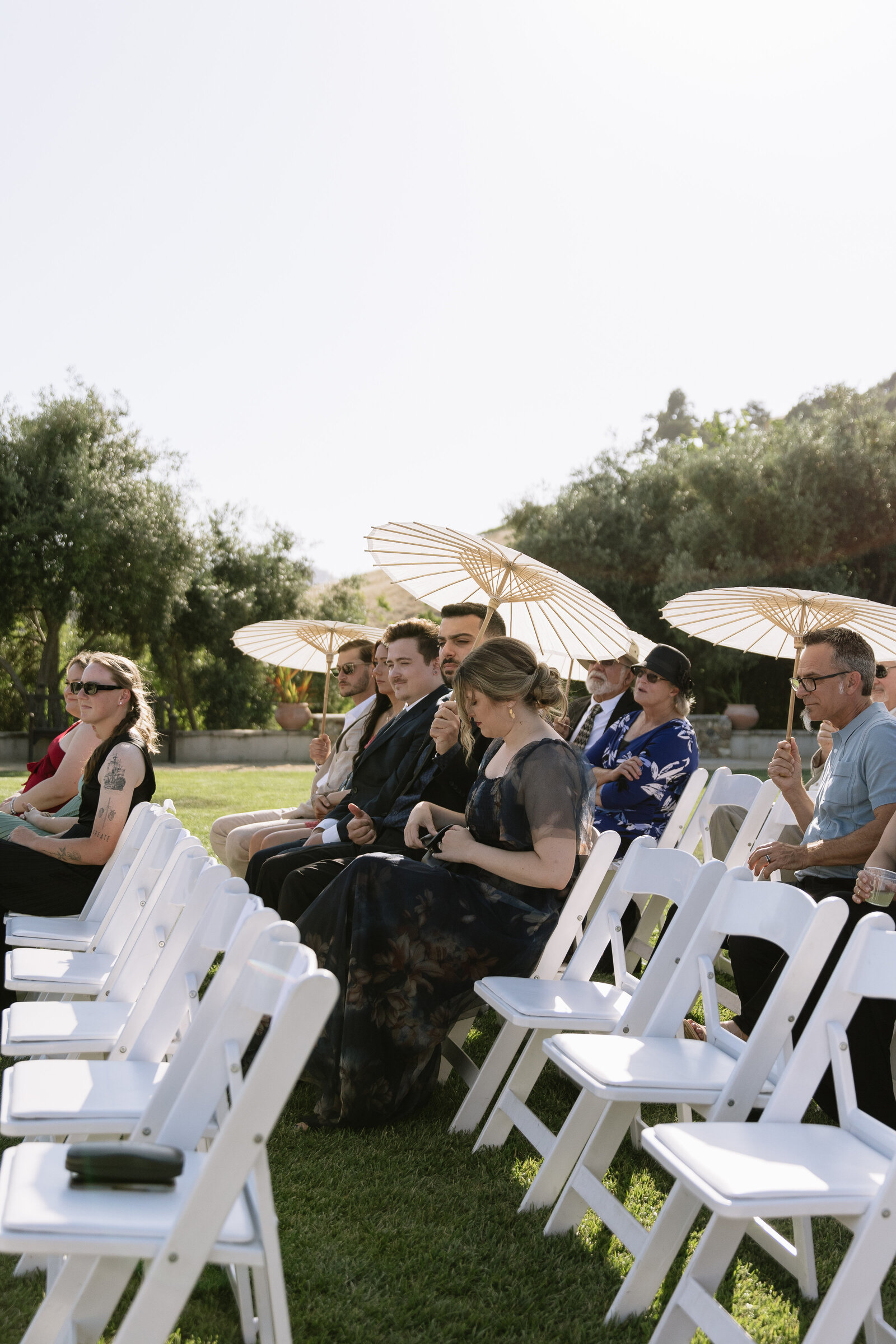 wedding guests gather in anticipation for beautiful outdoor ceremony