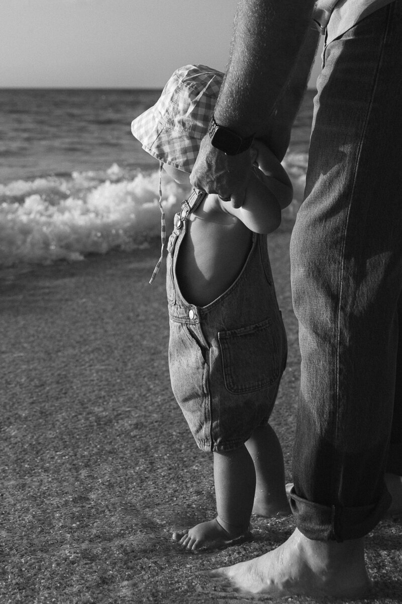 mom holding son's hand taken by naples family photographers
