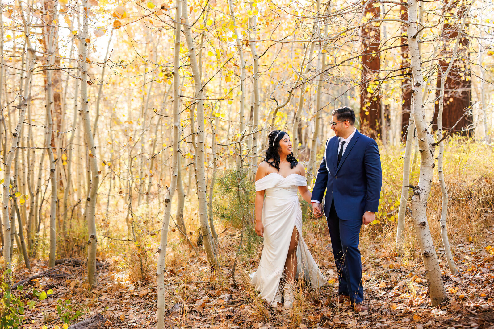 bride and groom walking in a yellow aspen grove in lake tahoe