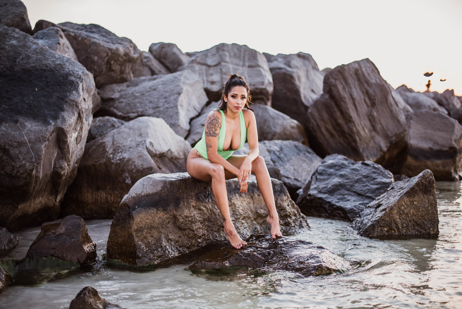 woman sitting on a rock in Destin, FLorida