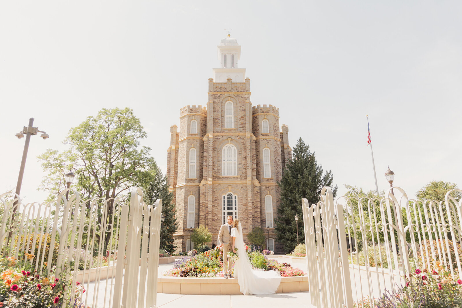 Beautiful scene of couple in the distance during their wedding at the Logan, Utah Temple taken by Utah Wedding Photographer, Robin.