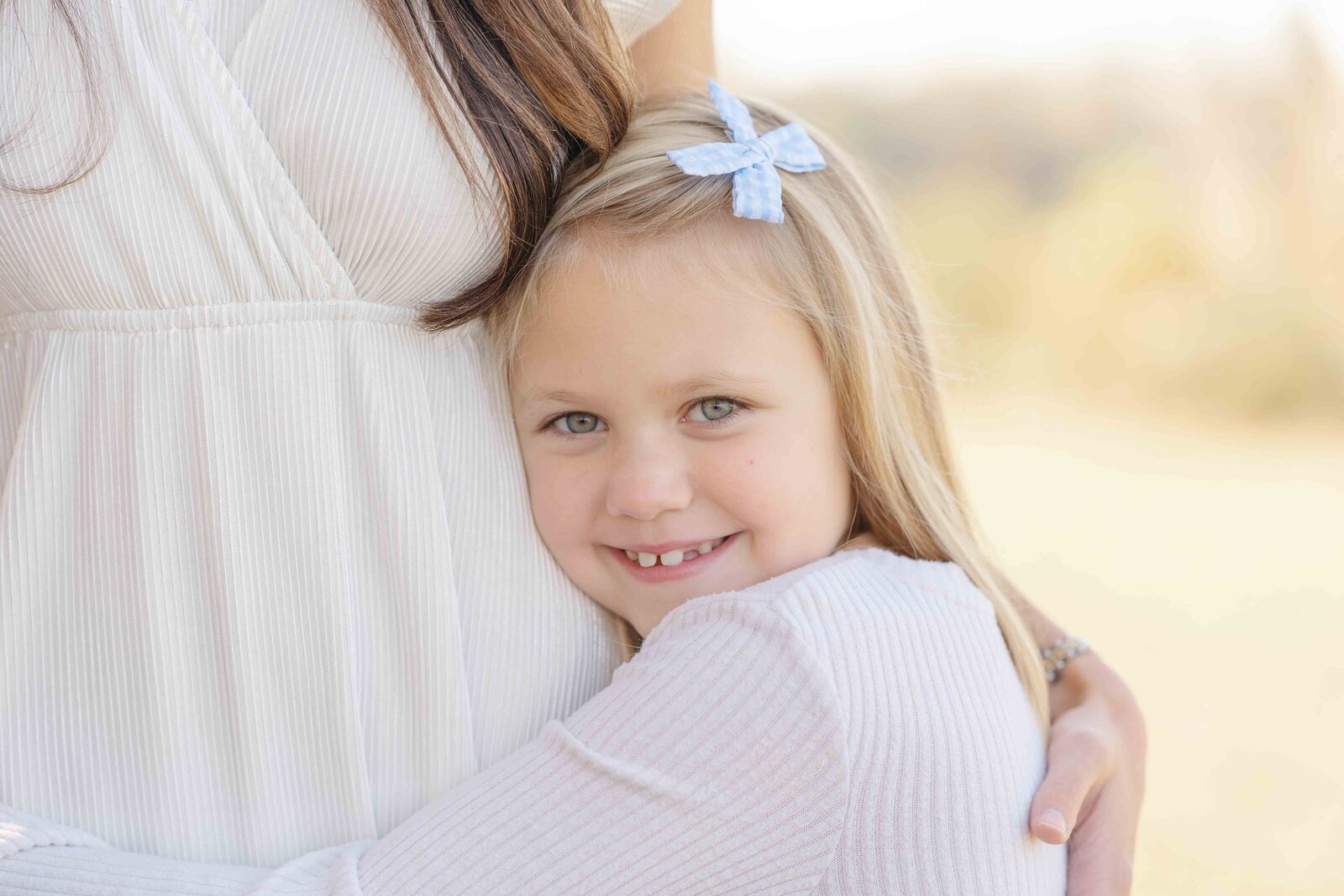 girl hugs sister during fall mini session in Haymarket, VA