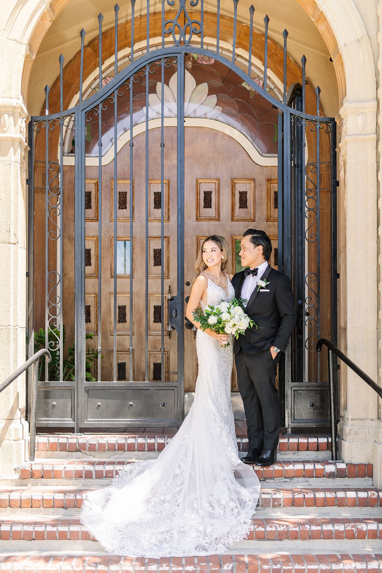 Bride and Groom standing outside doors at Waldorf Astoria Monarch Beach Resort and Club in Dana Point, California by wedding photographer, Sherr Weddings, based in Orange County, California.