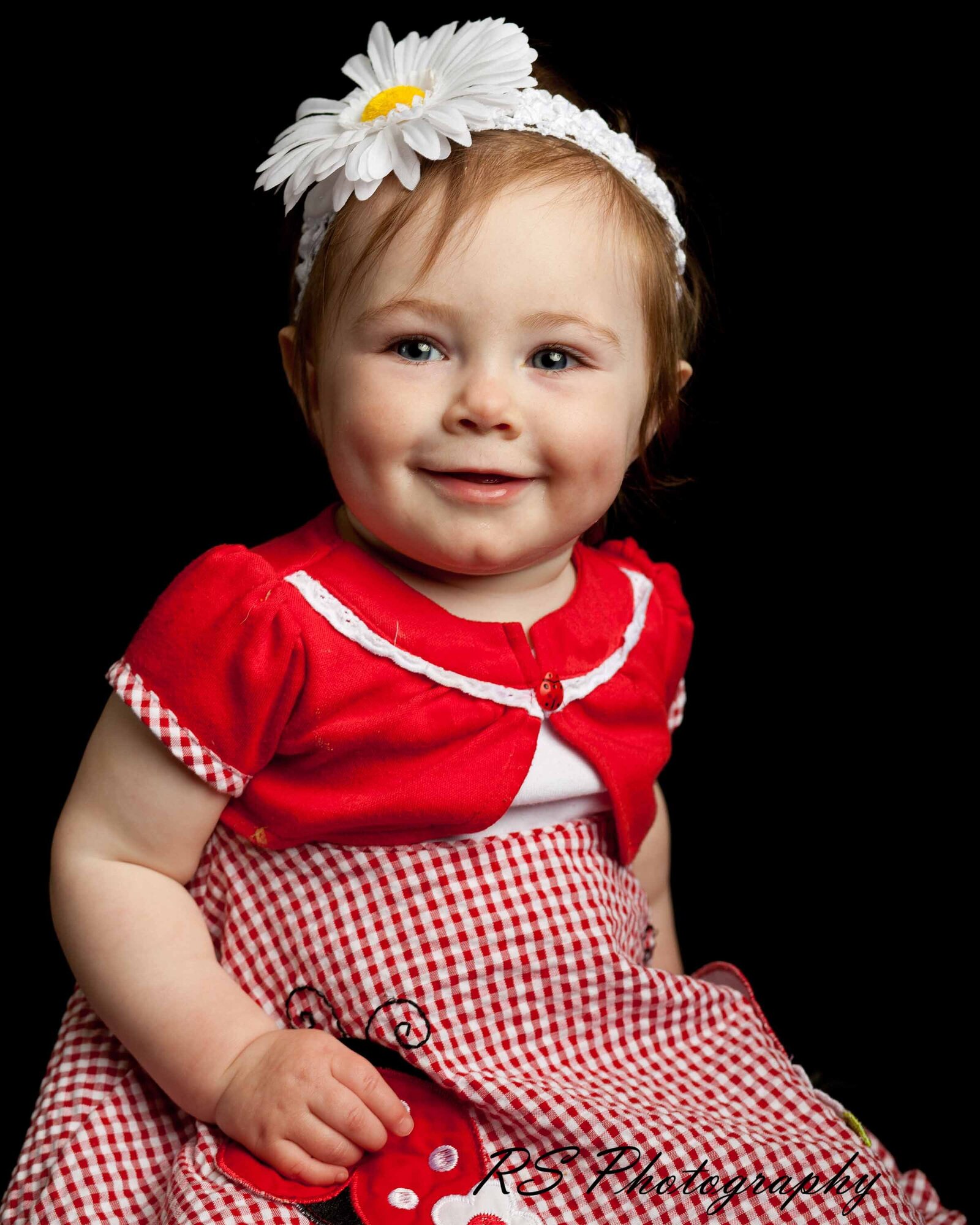 A little girl posing in studio shoot with Ron Schroll Photography in Asheville, NC